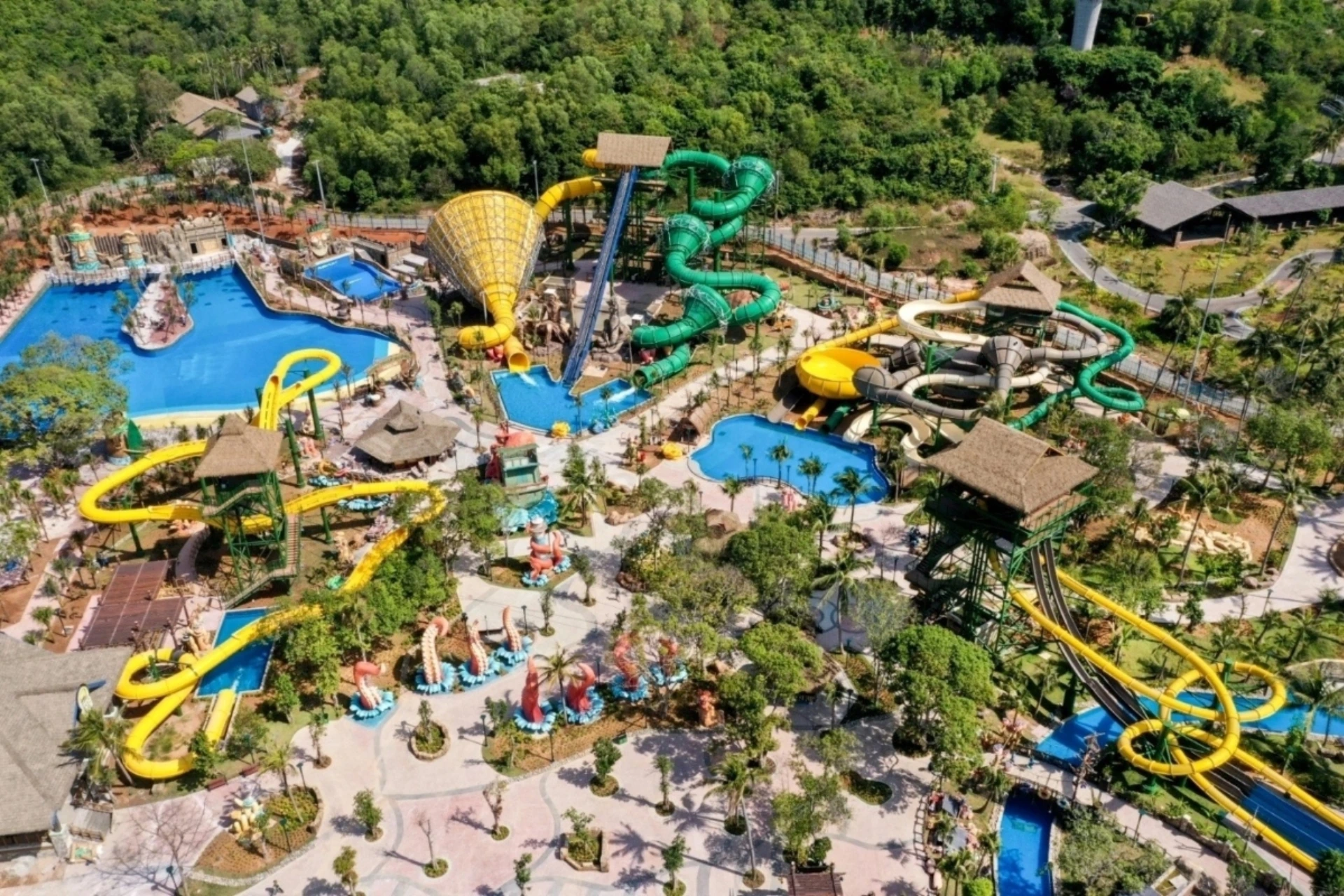 Aquatopia water park with yellow and green slides and pools