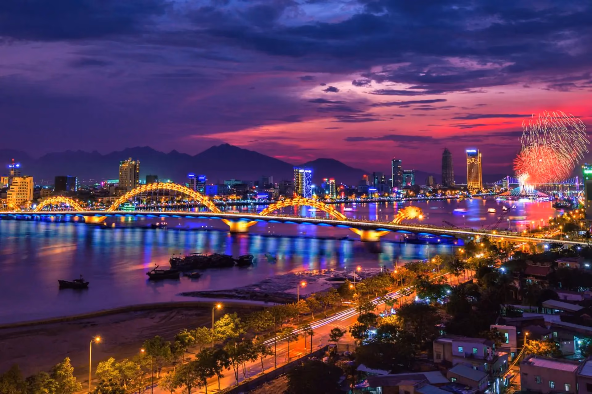 Illuminated dragon bridge over water in Da Nang Vietnam at dusk