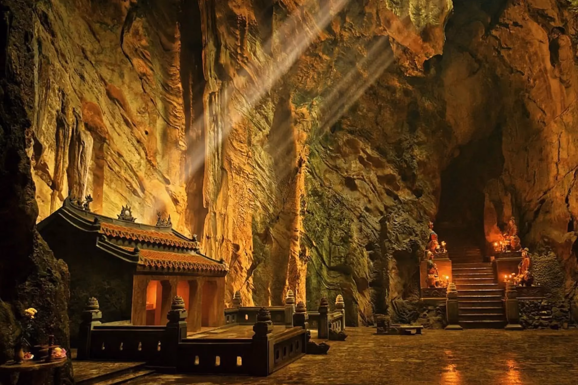 Marble Mountains cave temple lit by golden lights at night