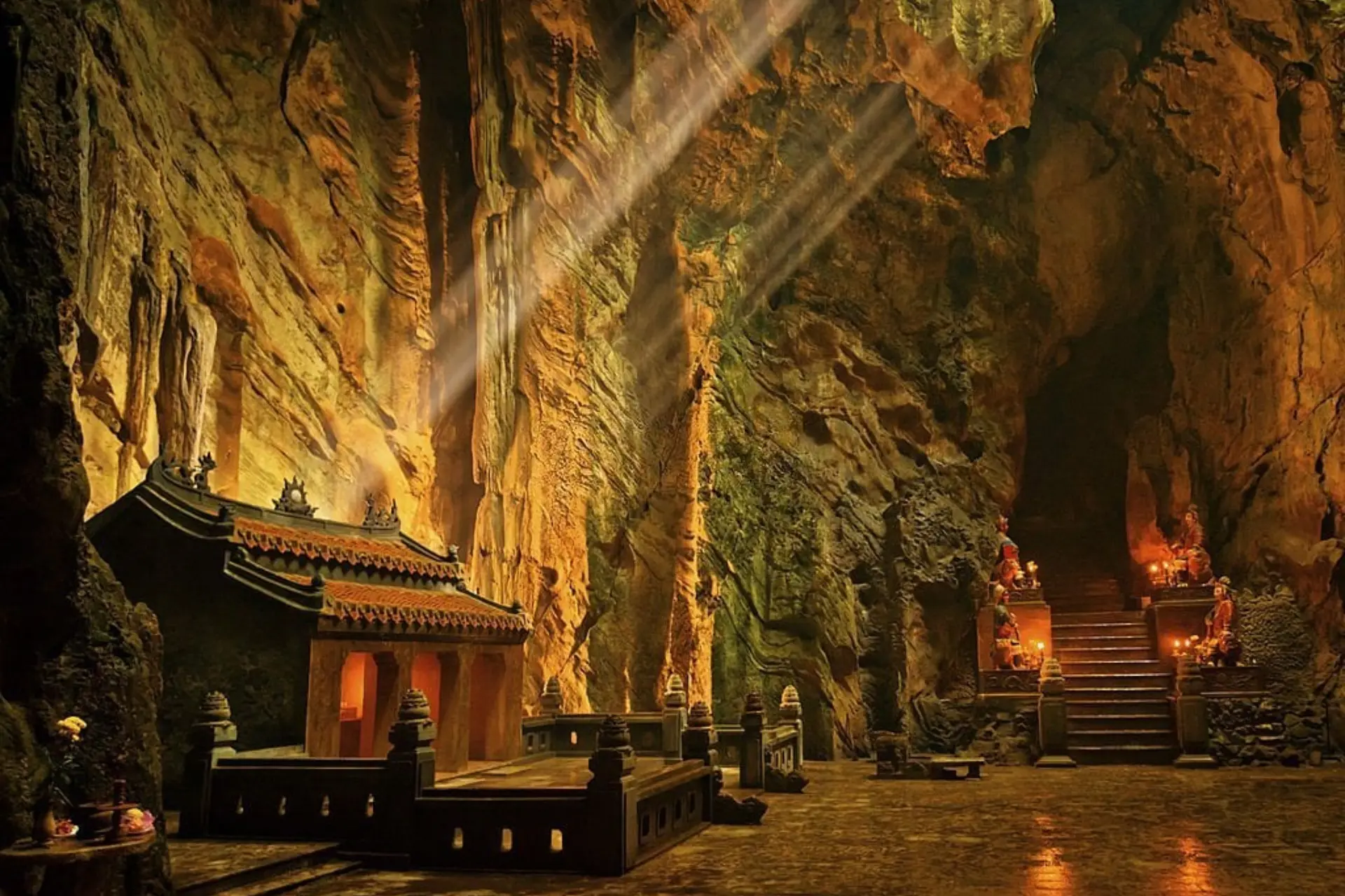 Marble Mountains cave temple lit by golden lights at night