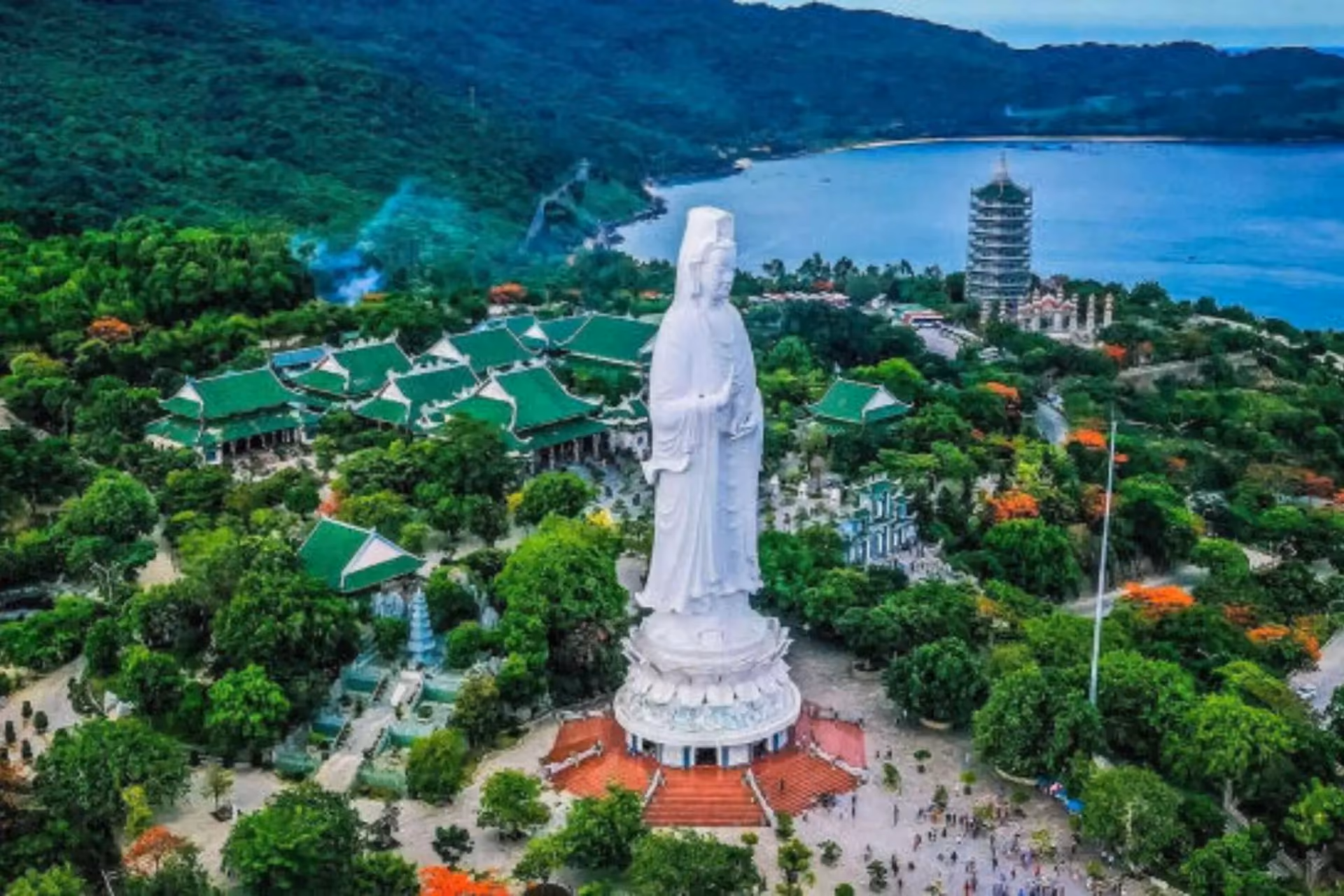 White statue at Linh Ung Pagoda overlooking bay and temples