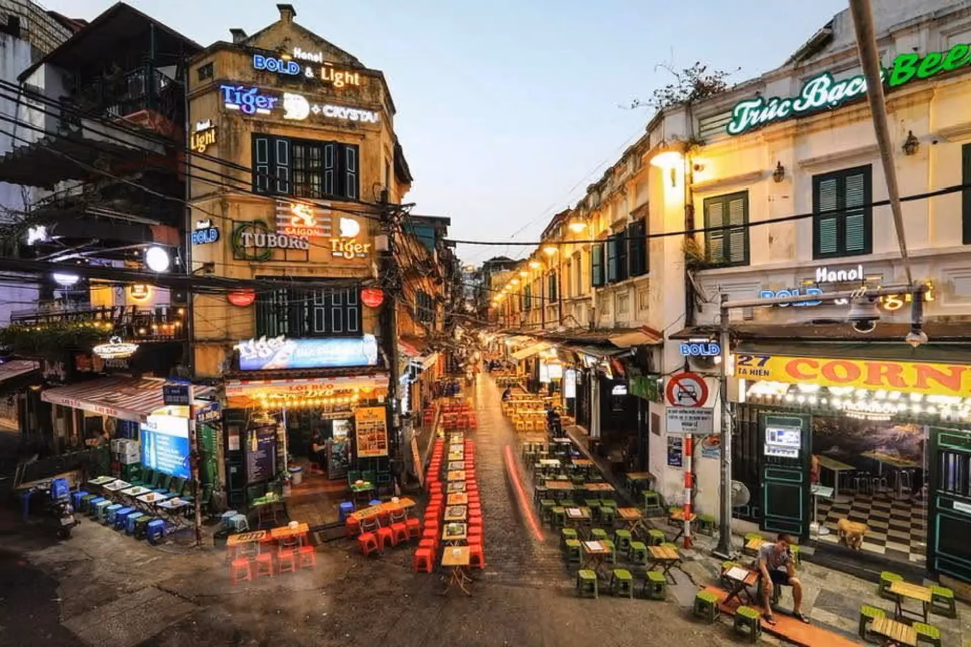 Hanoi Old Quarter street with colorful plastic chairs and beer signs