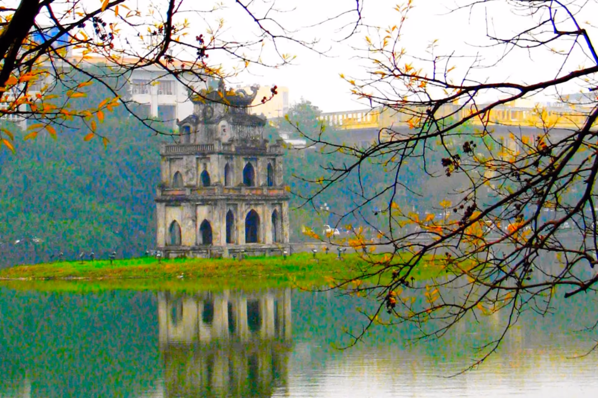 Turtle Tower reflected in green water at Hoan Kiem Lake