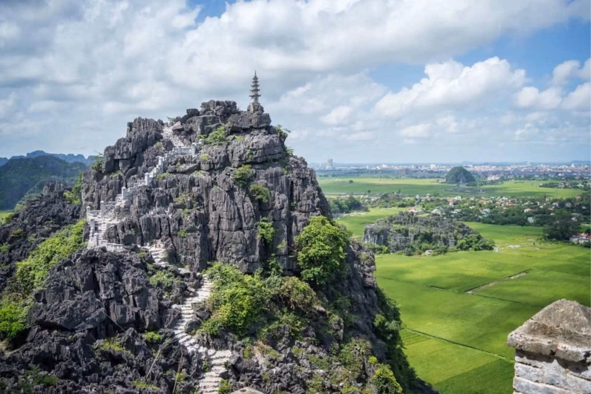 Stone peak with temple and stairs at Hang Mua Vietnam