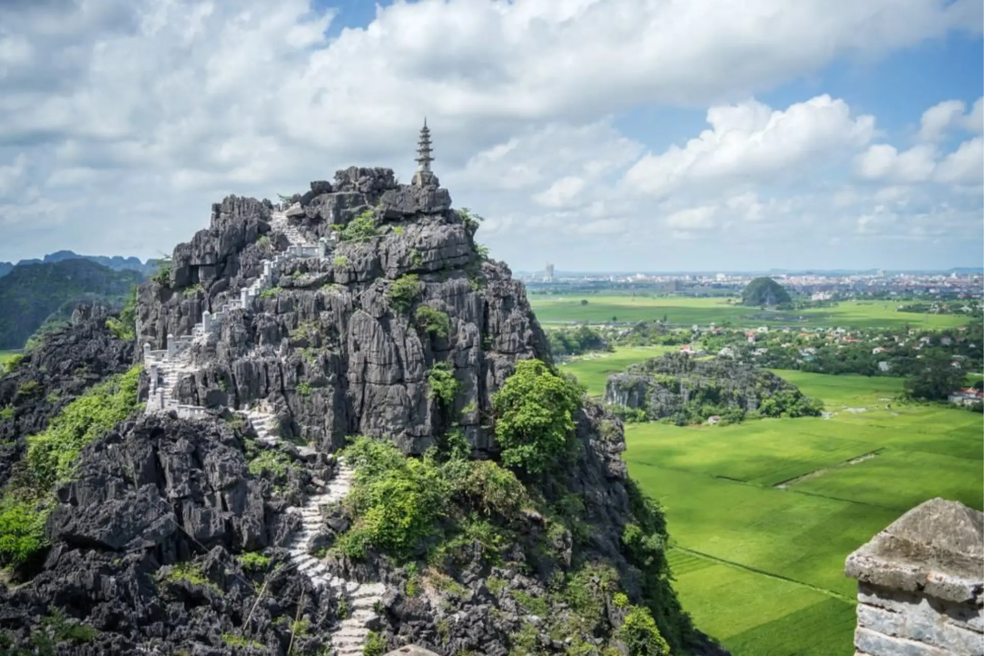 Stone peak with temple and stairs at Hang Mua Vietnam