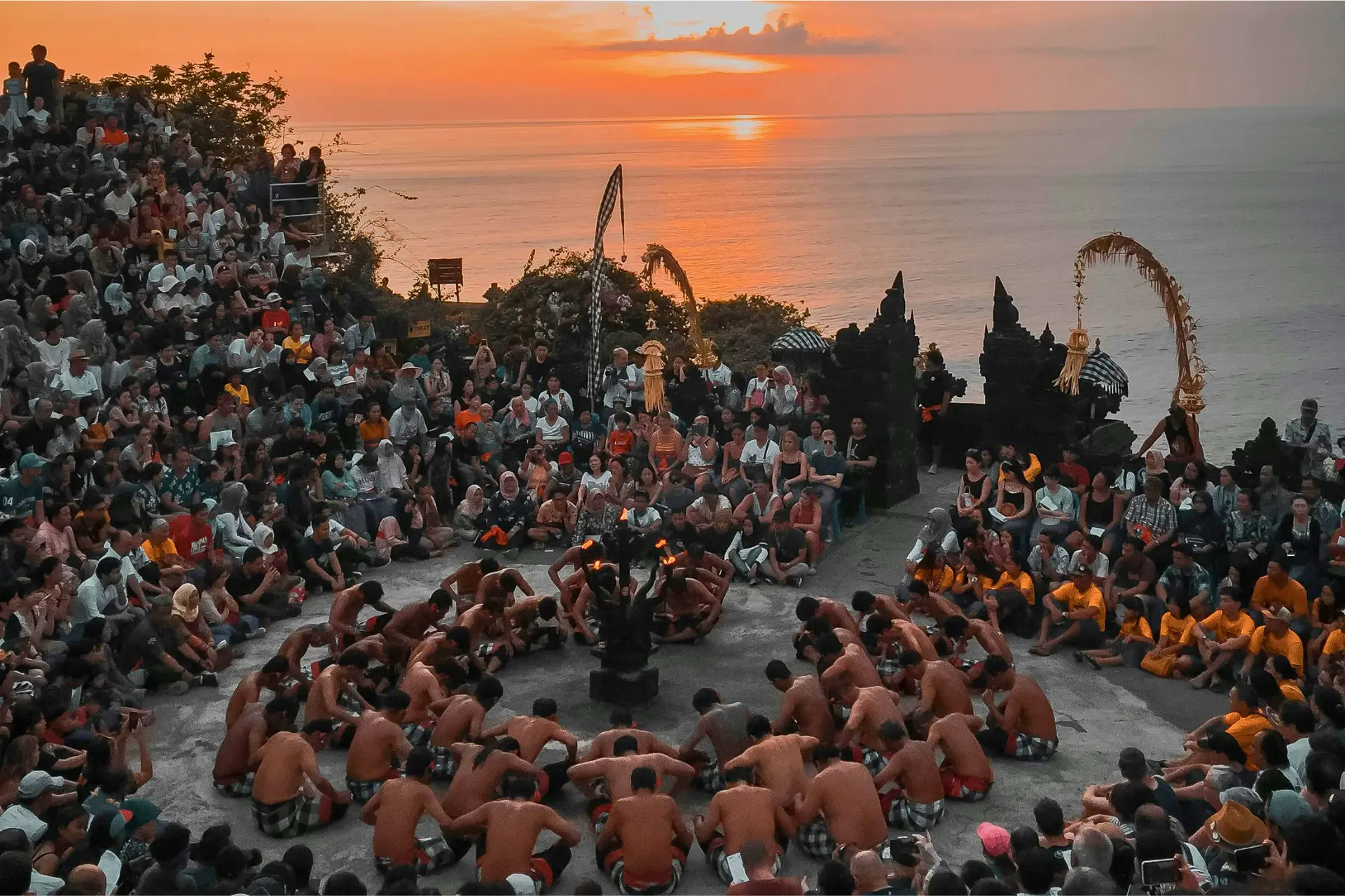 Kecak dance performers and crowds at sunset in Bali