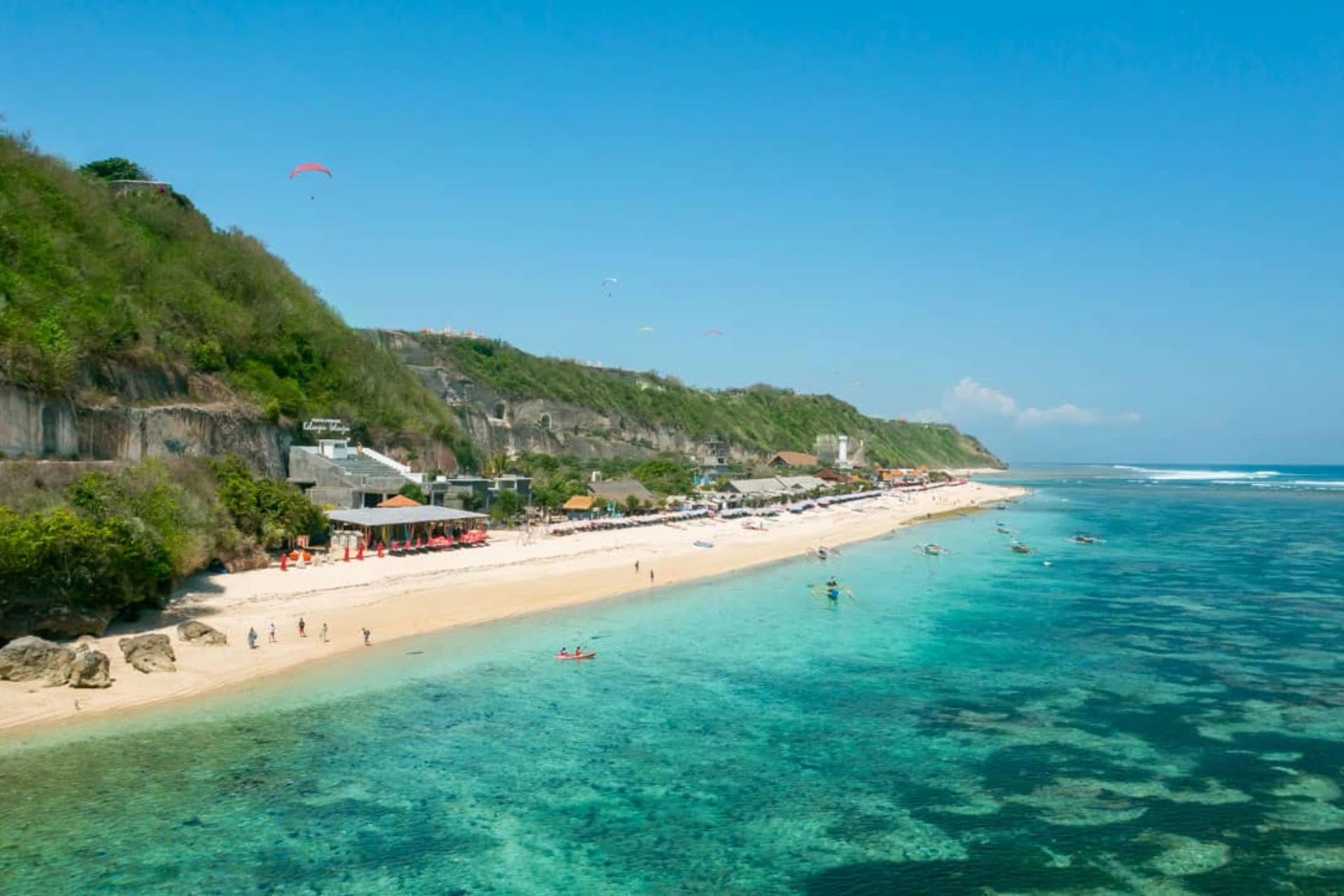 Pandawa Beach with clear water and cliff-side shops