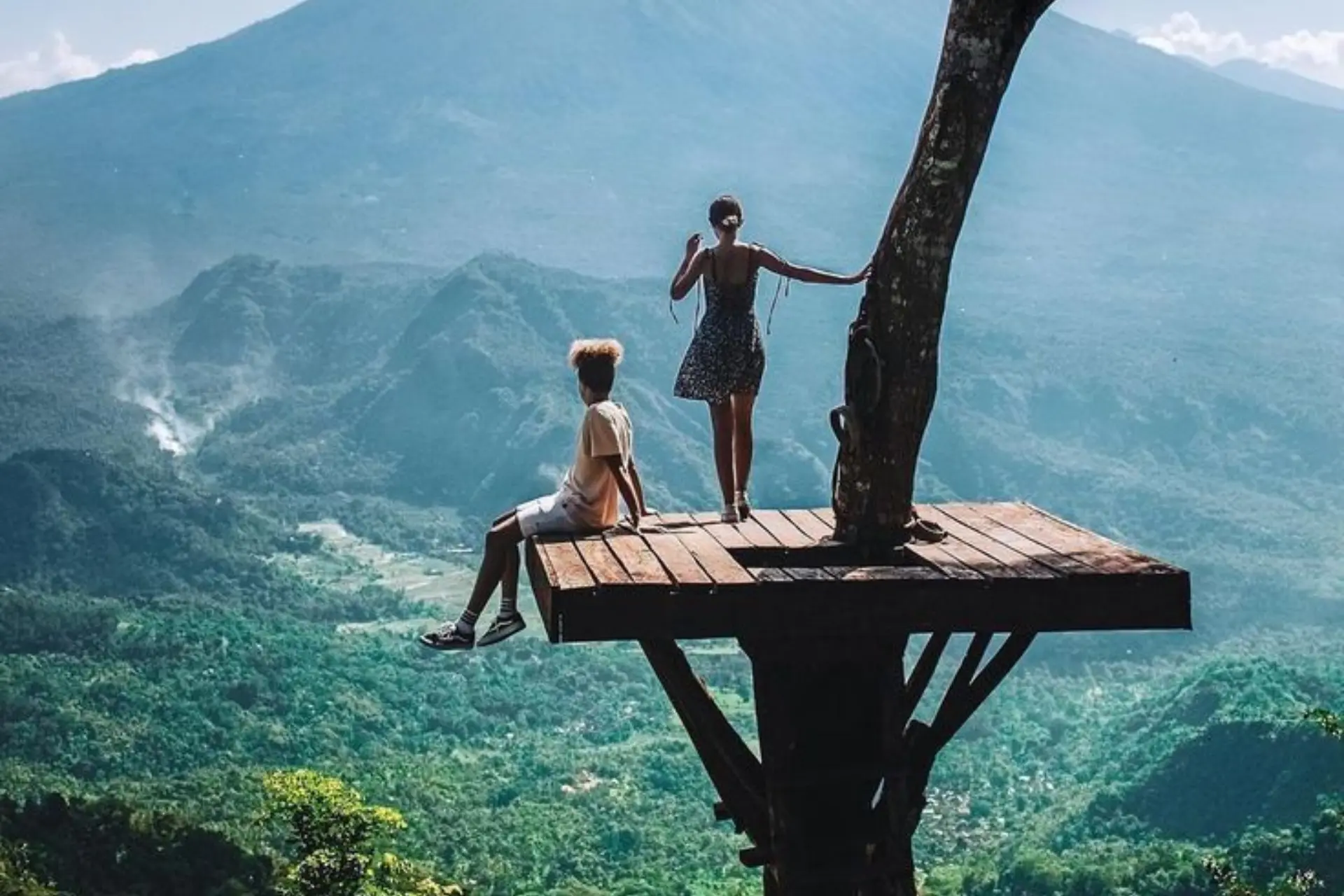Two people on wooden platform overlooking Bali valley