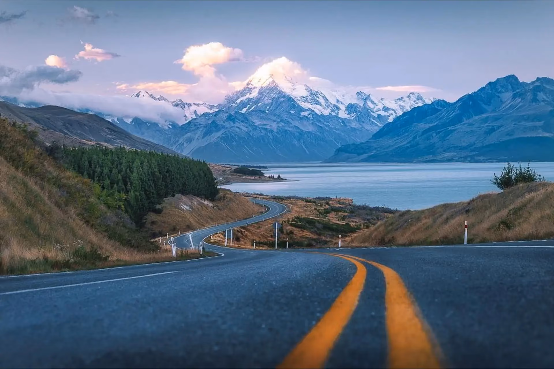 Road leading to snow-capped mountain over Lake Pukaki