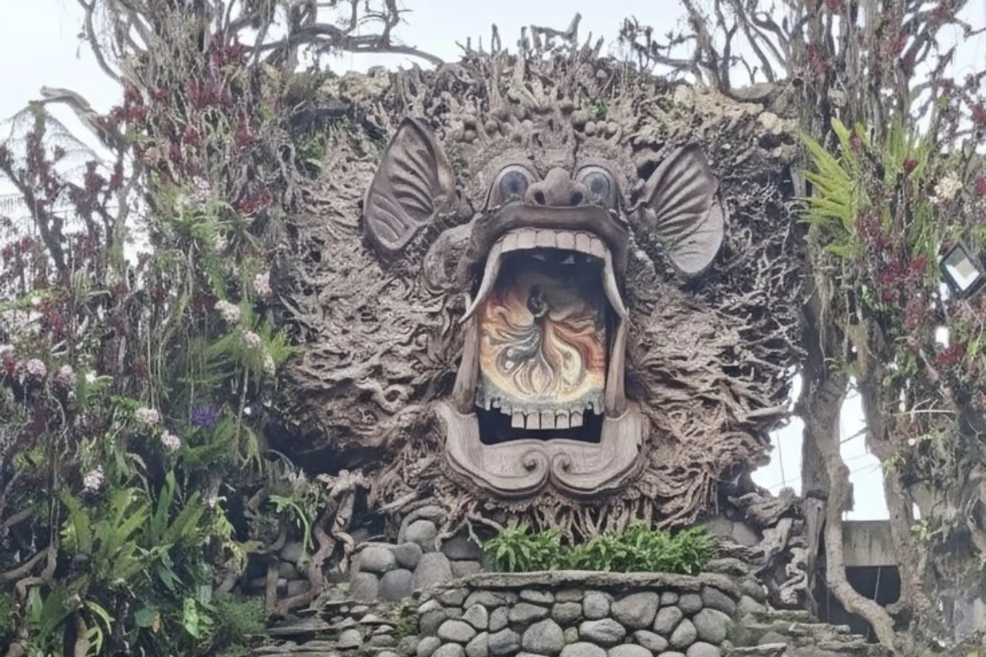 Ornate stone demon head gateway at Bali Sari Timbul