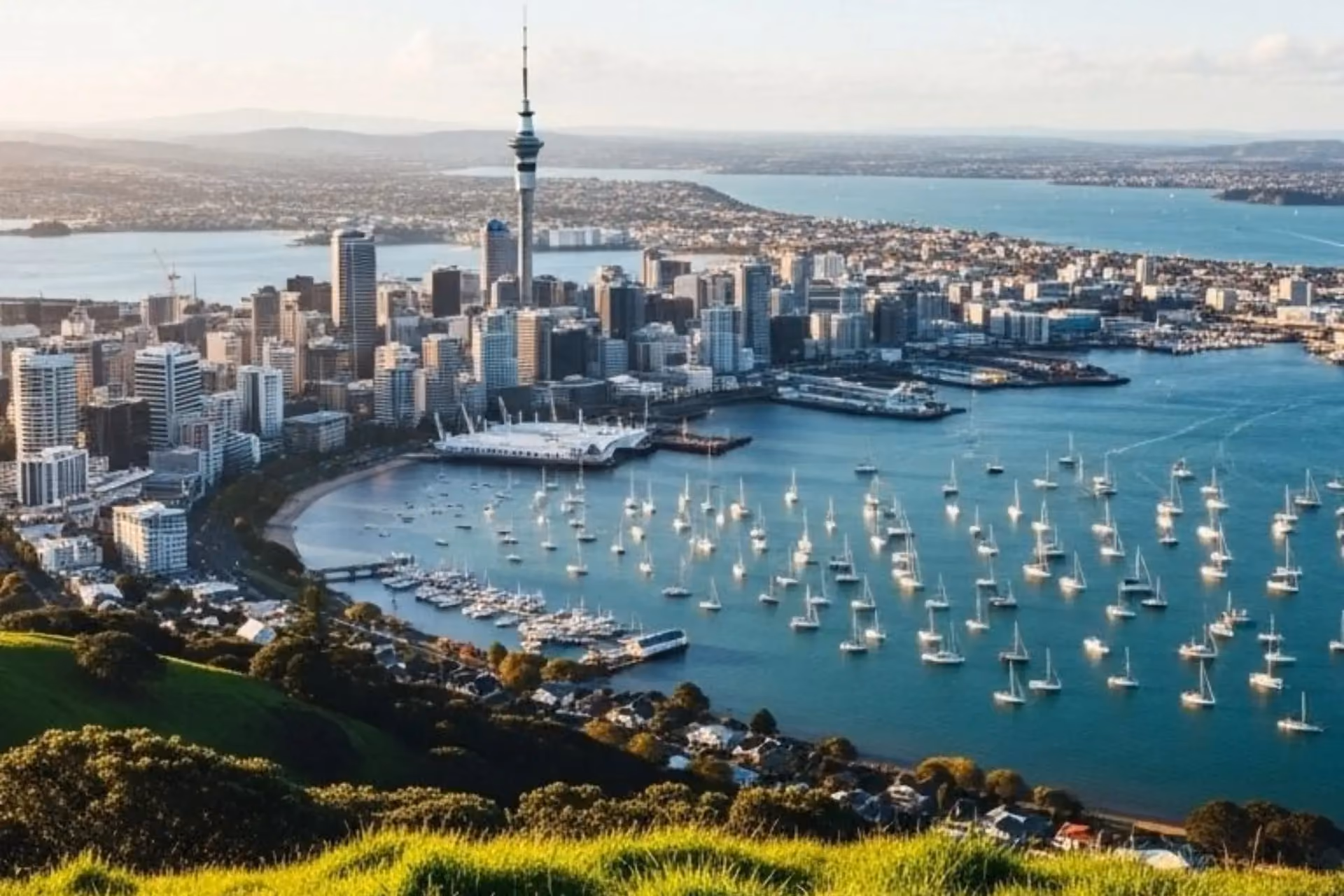 Auckland city skyline with sailboats on blue water