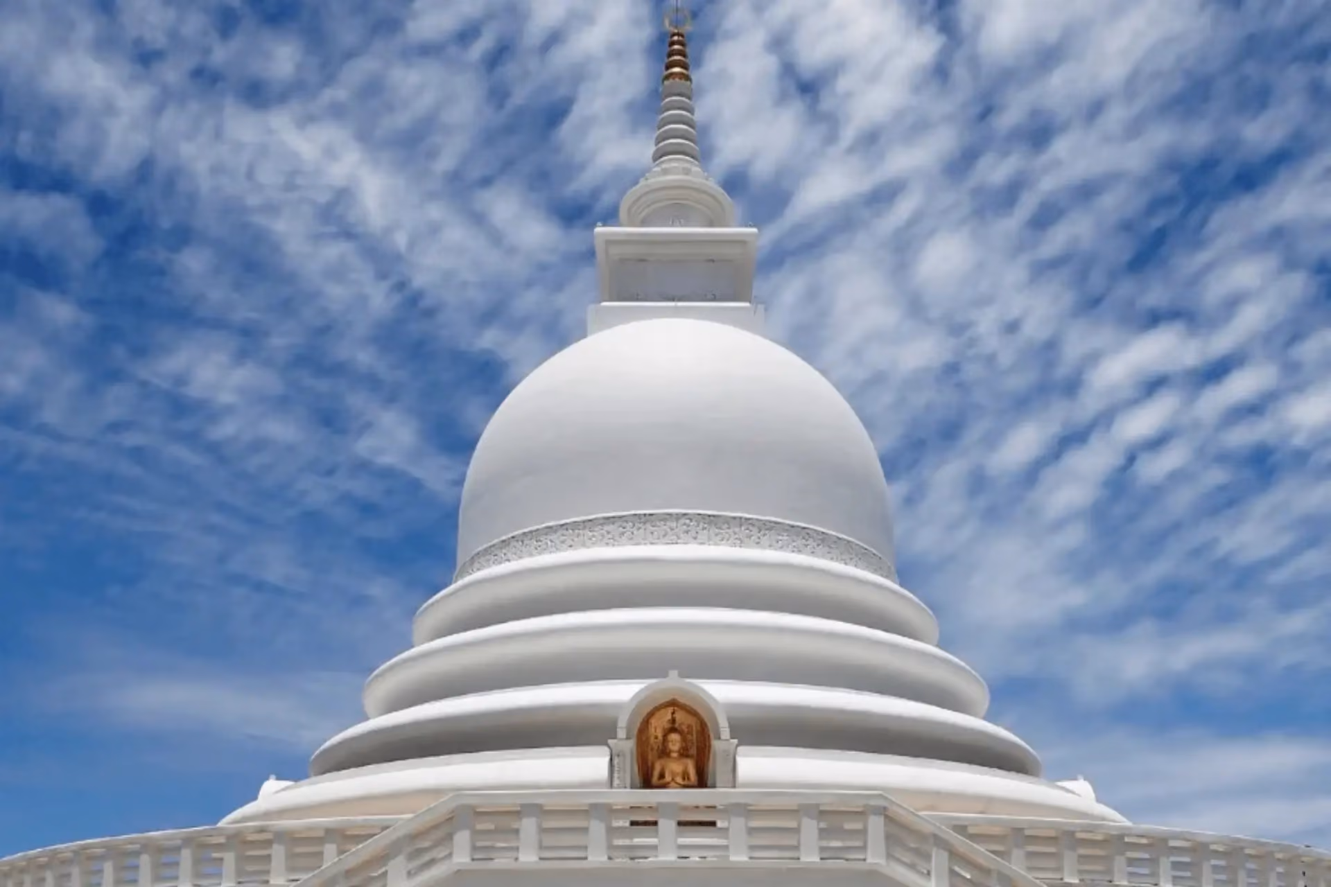 White domed pagoda with spire against blue sky, Mirissa