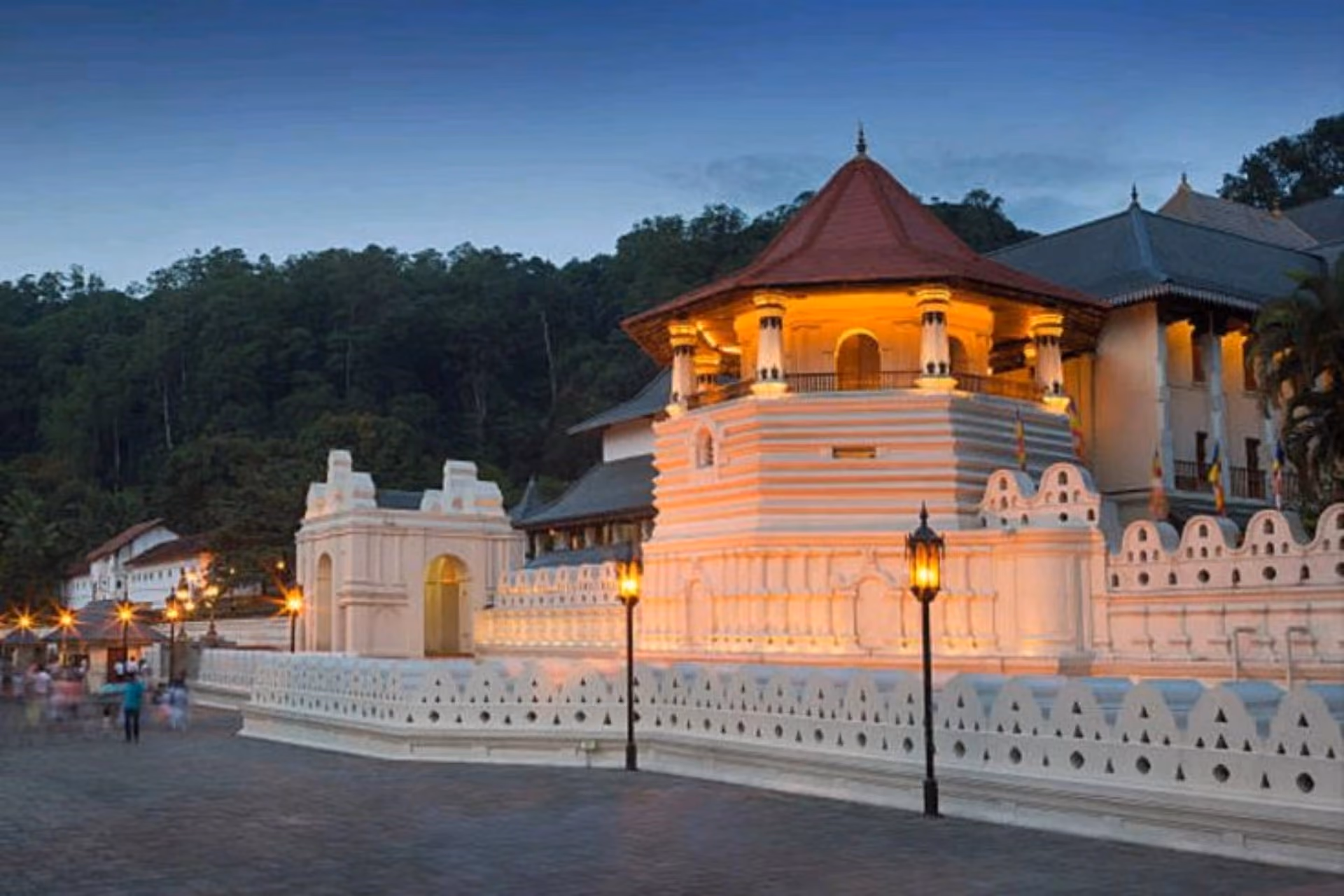 Temple of Tooth Relic lit up at dusk in Sri Lanka