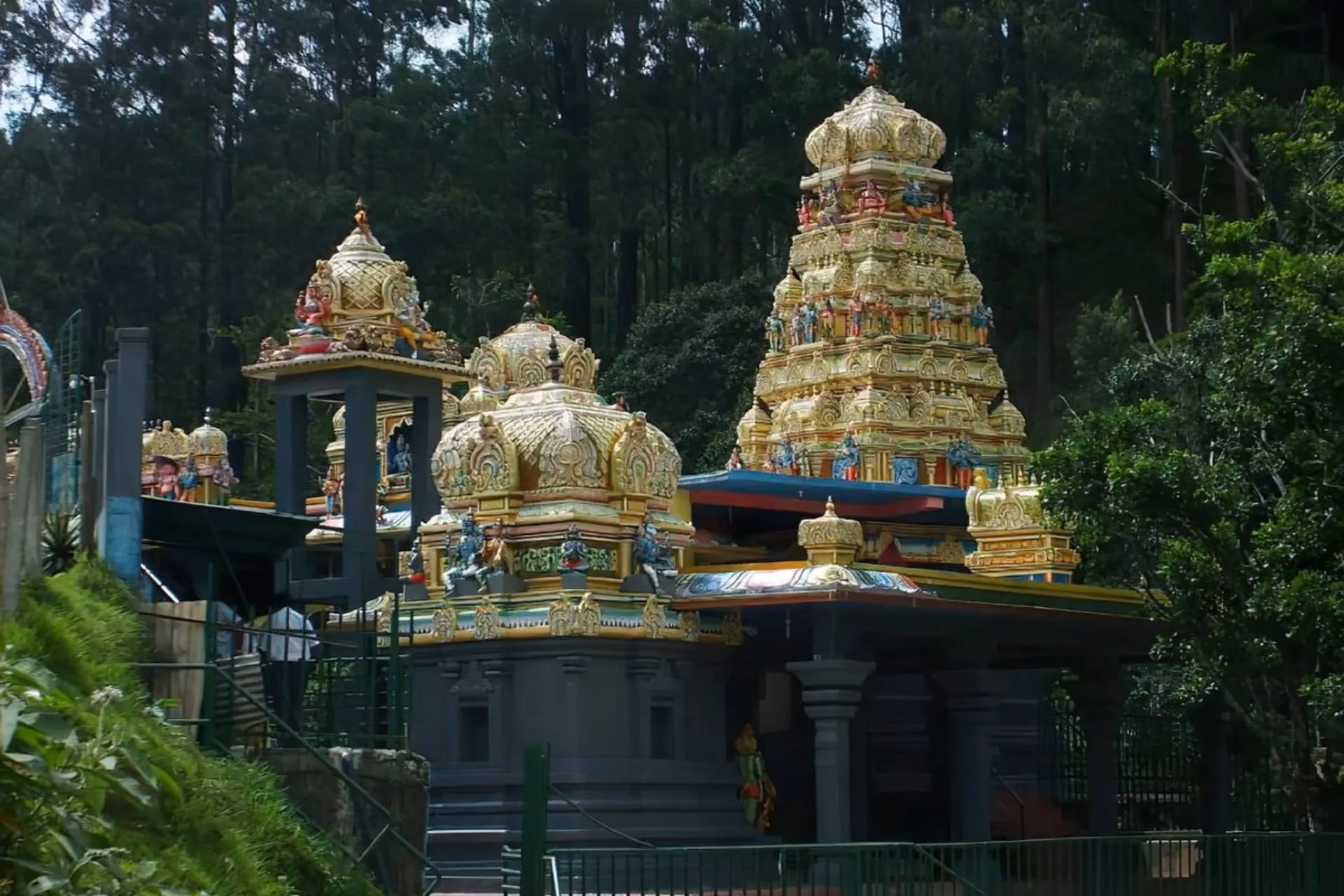 Sita Amman Temple with gold domes among tall trees