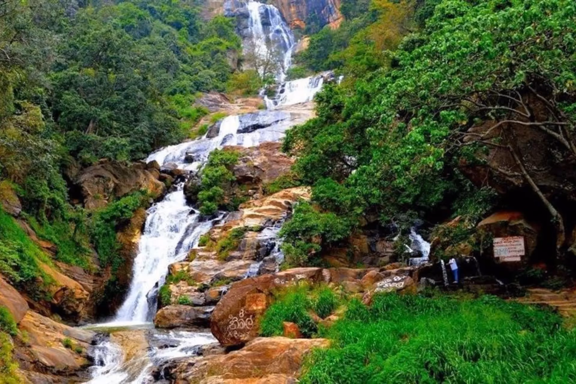 Ravana Falls cascading down lush green forest in Sri Lanka