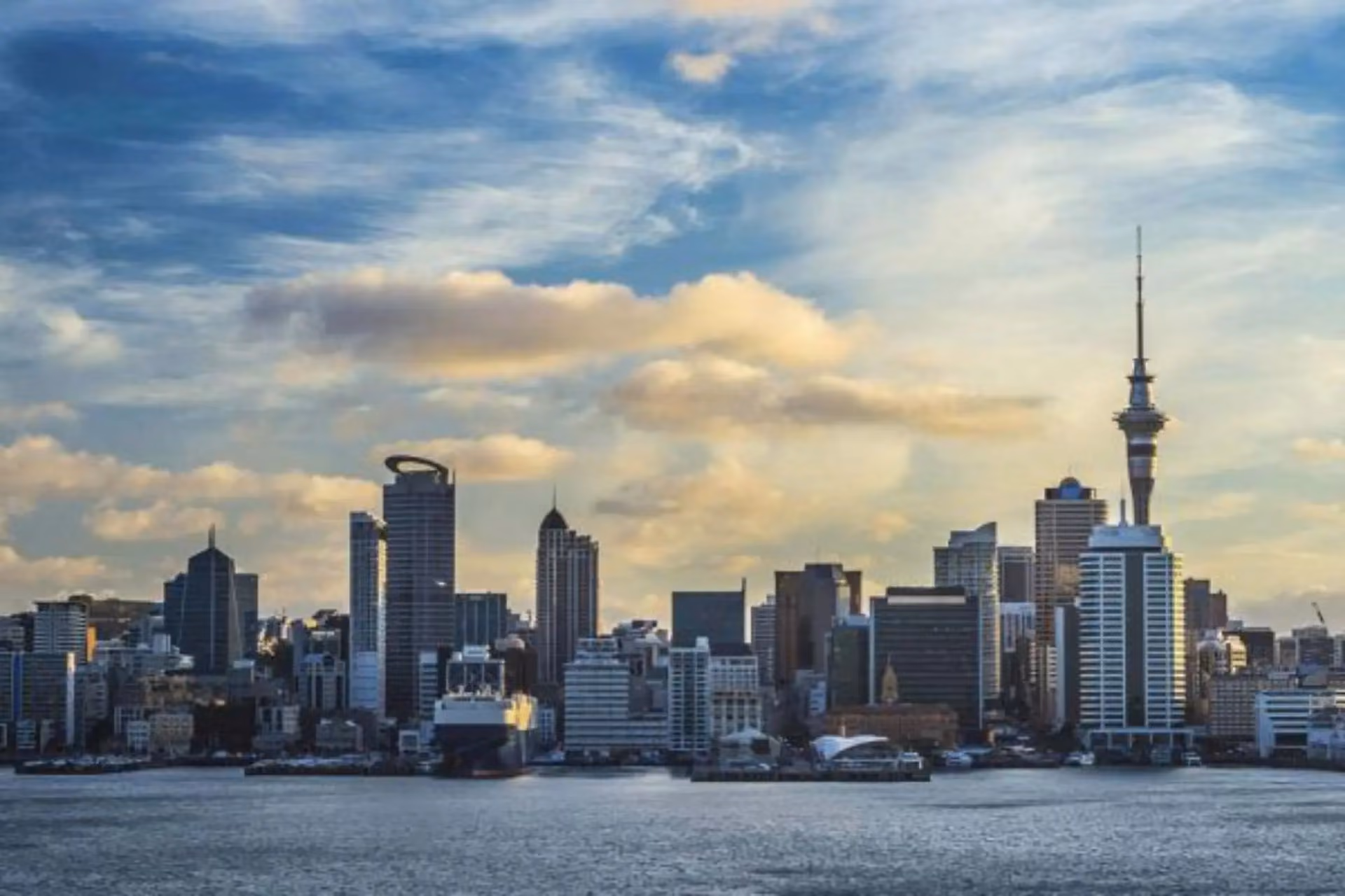 Auckland skyline with tall buildings and water in front