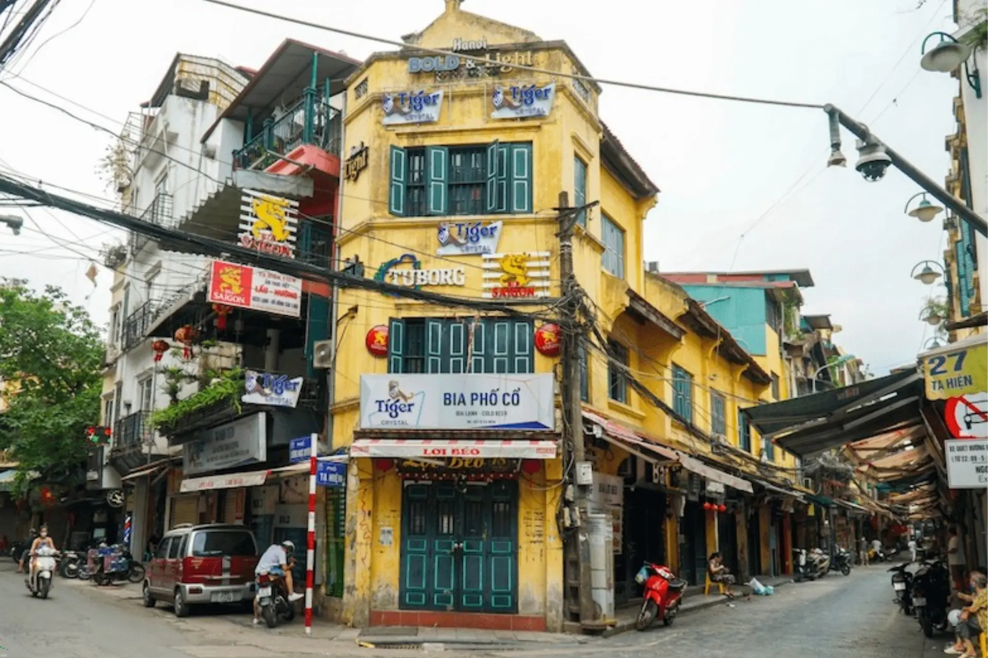 Yellow building with green doors in Hanoi Old Quarter