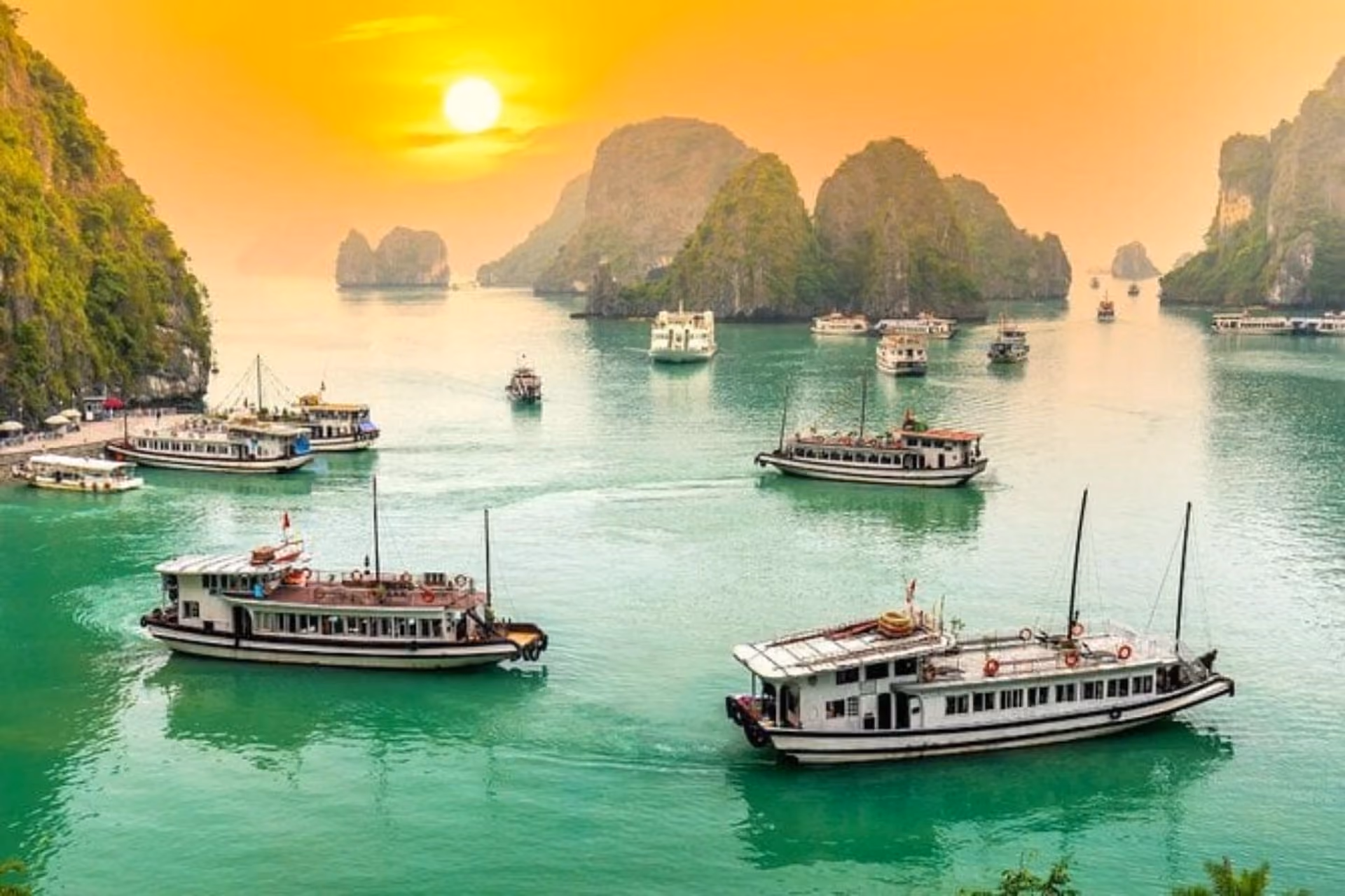 Tourist boats on blue-green water at Ha Long Bay Vietnam