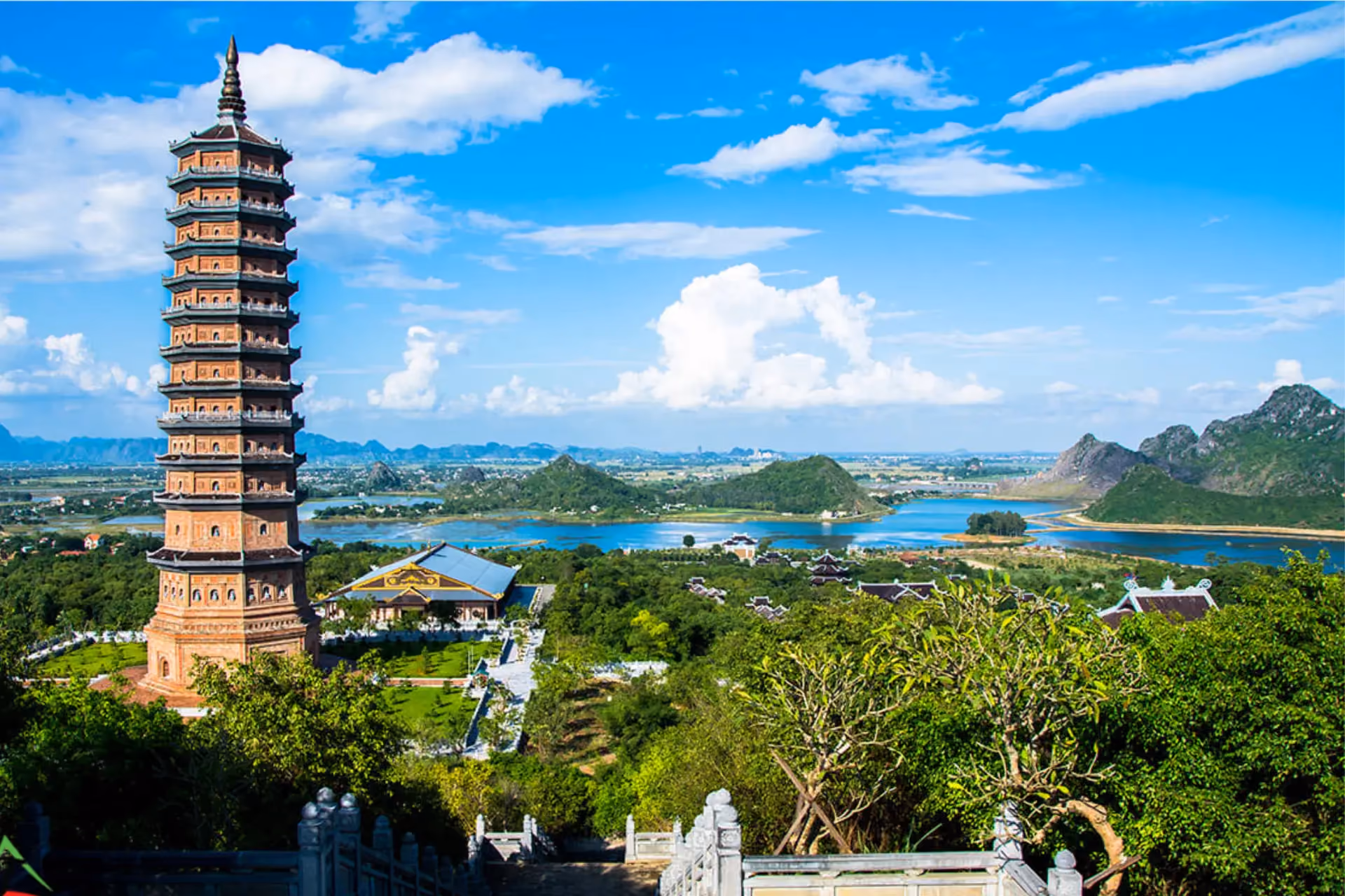 Bai Dinh Pagoda tower with lake and mountains behind