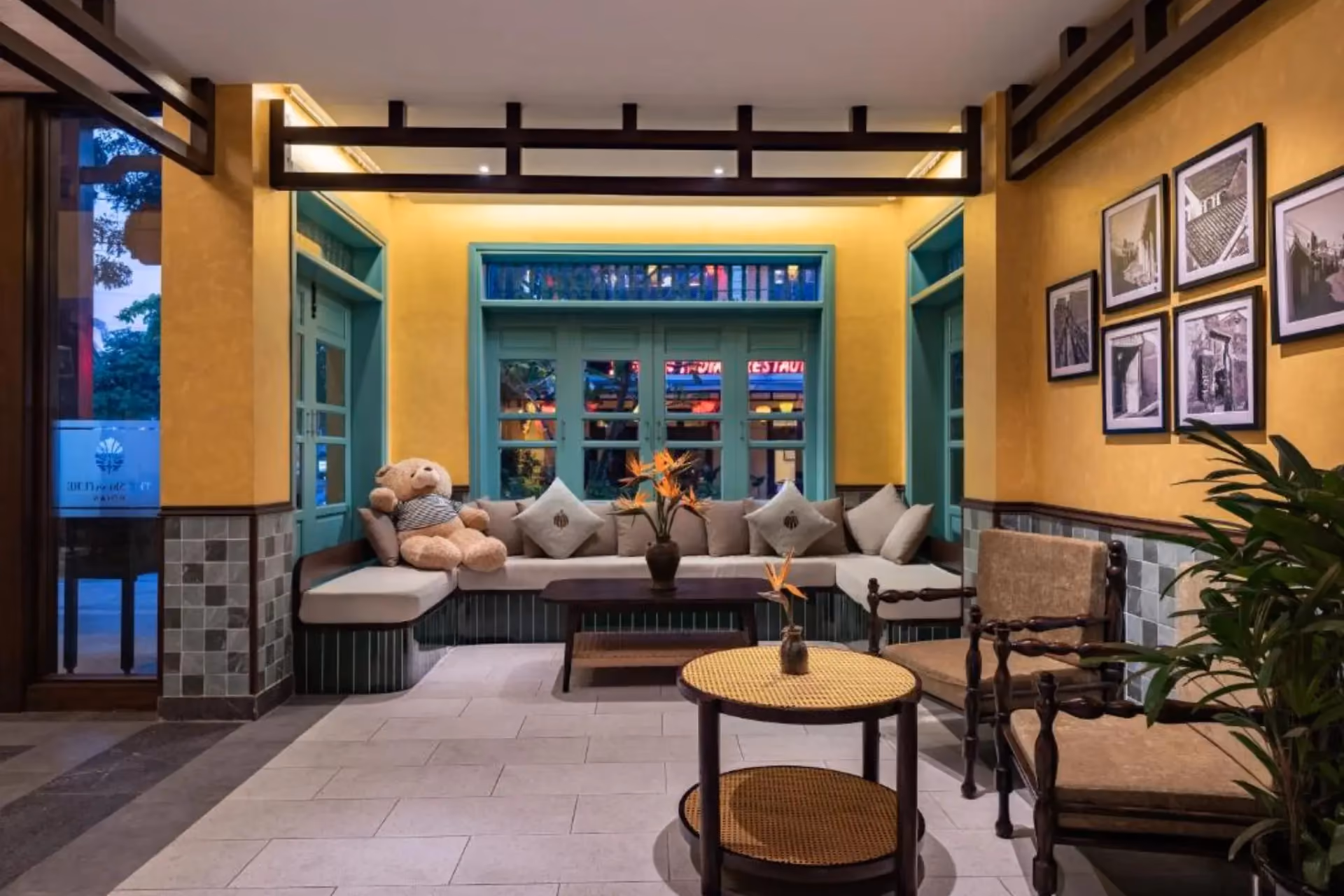 Hoi An hotel lobby with yellow walls and blue-green seating area