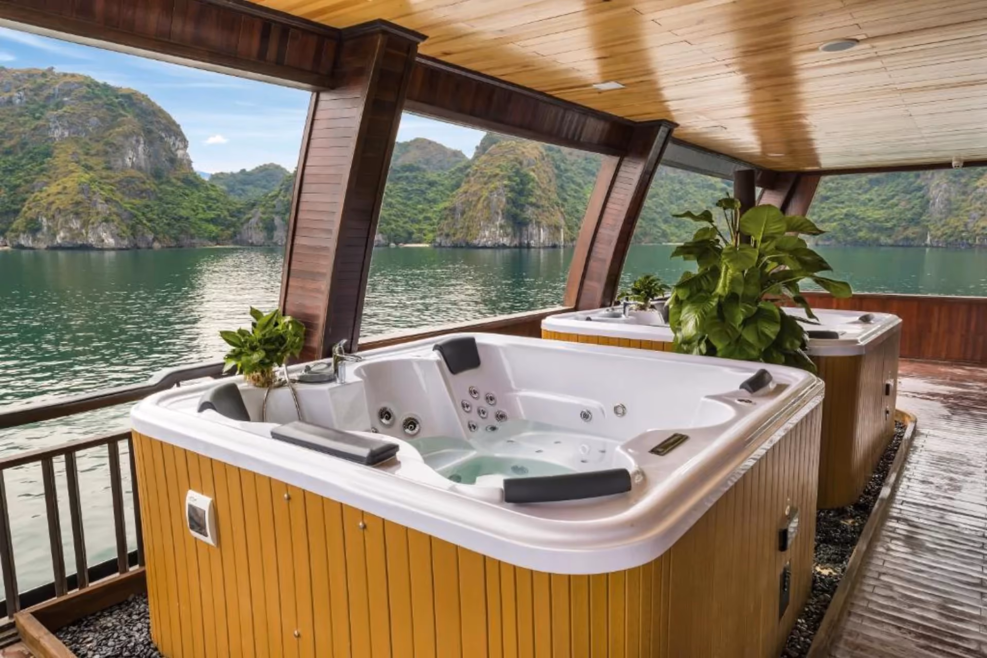 Hot tub on boat deck overlooking Halong Bay limestone cliffs