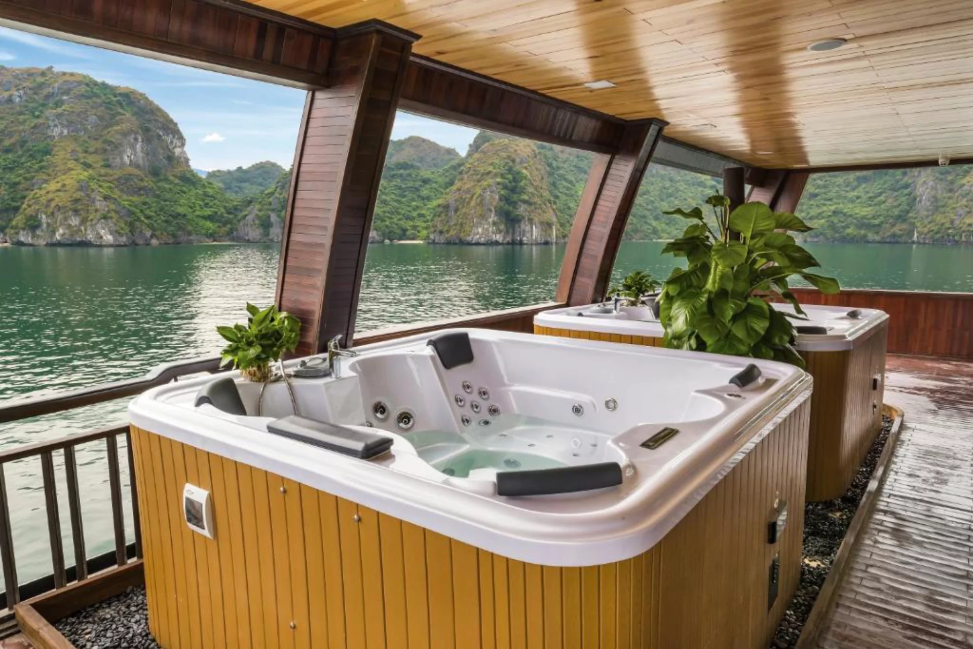Hot tub on boat deck overlooking Halong Bay limestone cliffs