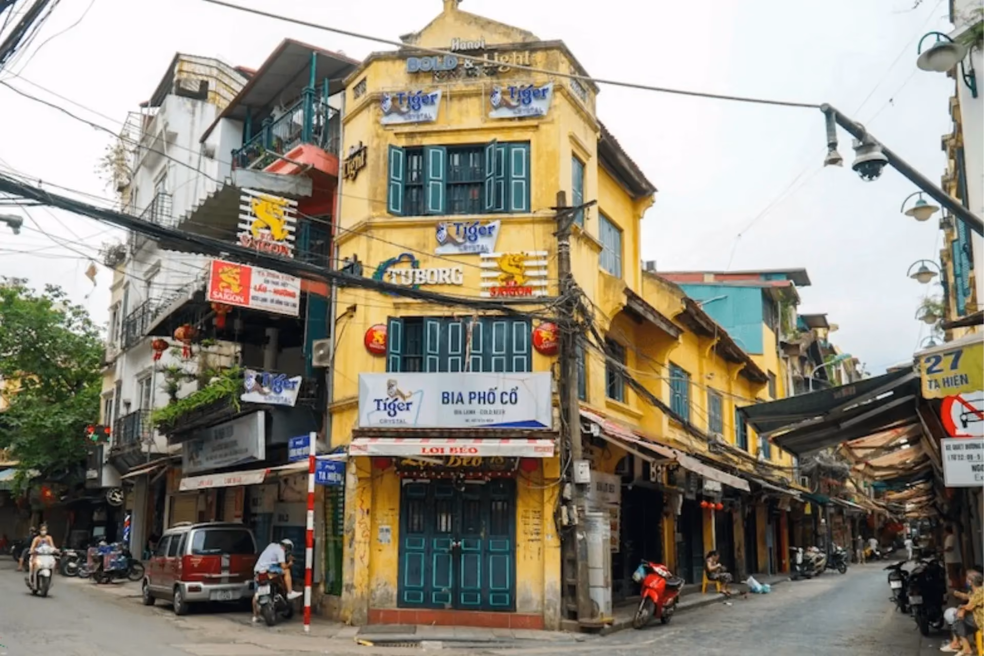 Yellow building with green doors in Hanoi Old Quarter