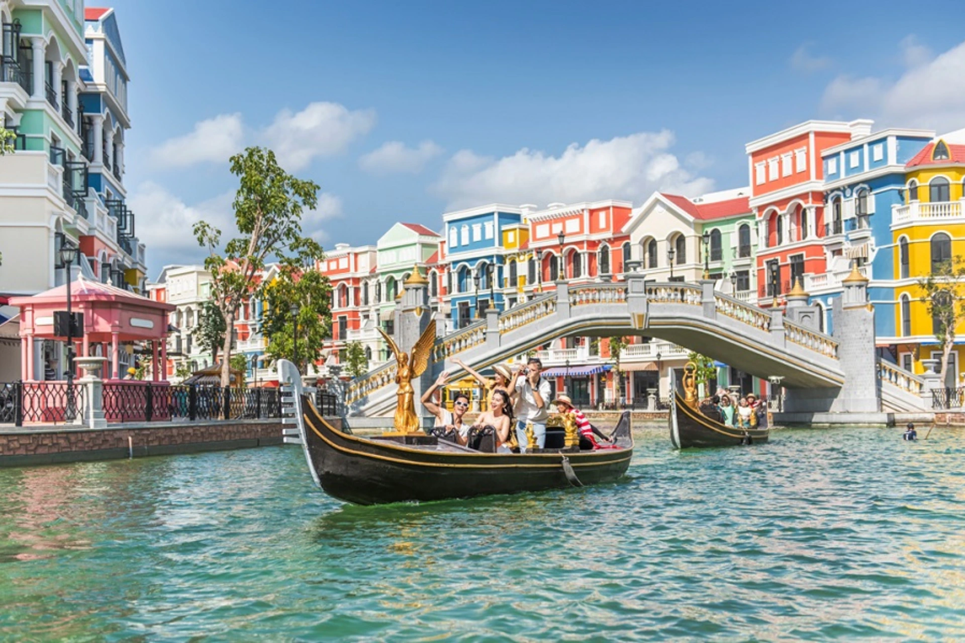 Gondolas on water at Grand World with colorful buildings