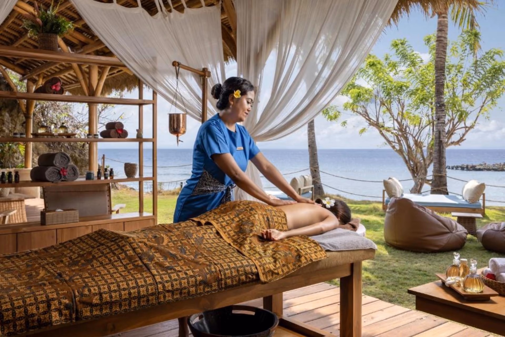 Therapist giving massage at Semaya Beach Spa by ocean