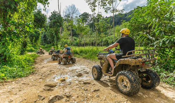 Group riding ATVs on muddy jungle trail in Phuket