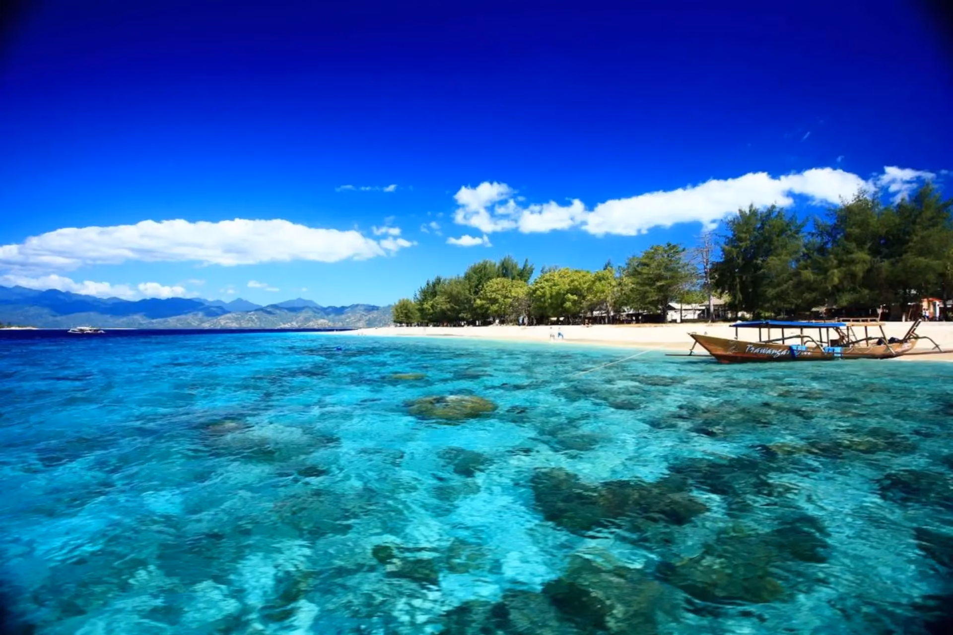 Clear blue water and sandy beach at Gili Islands Bali