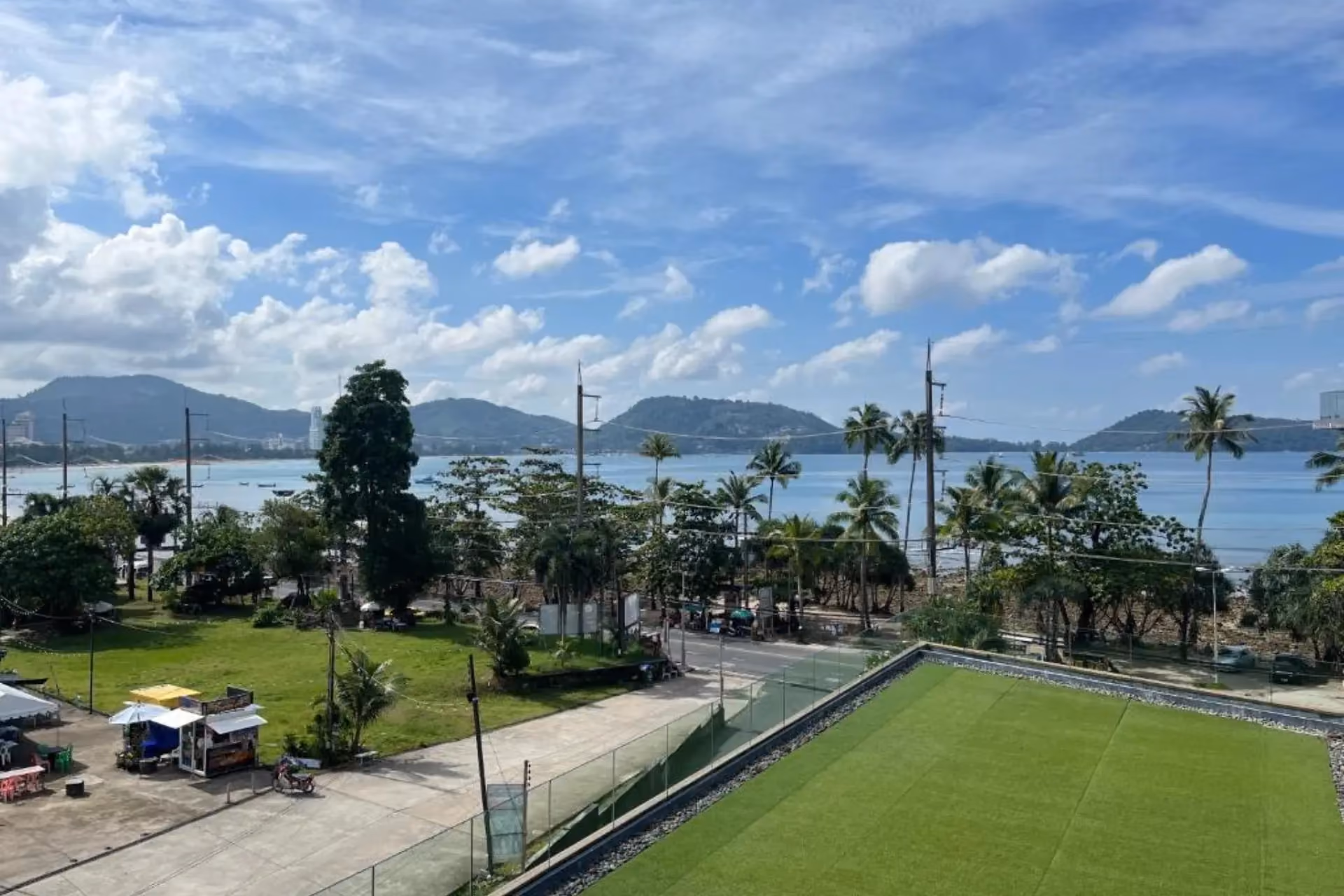 Green sports field overlooking bay and mountains in Phuket