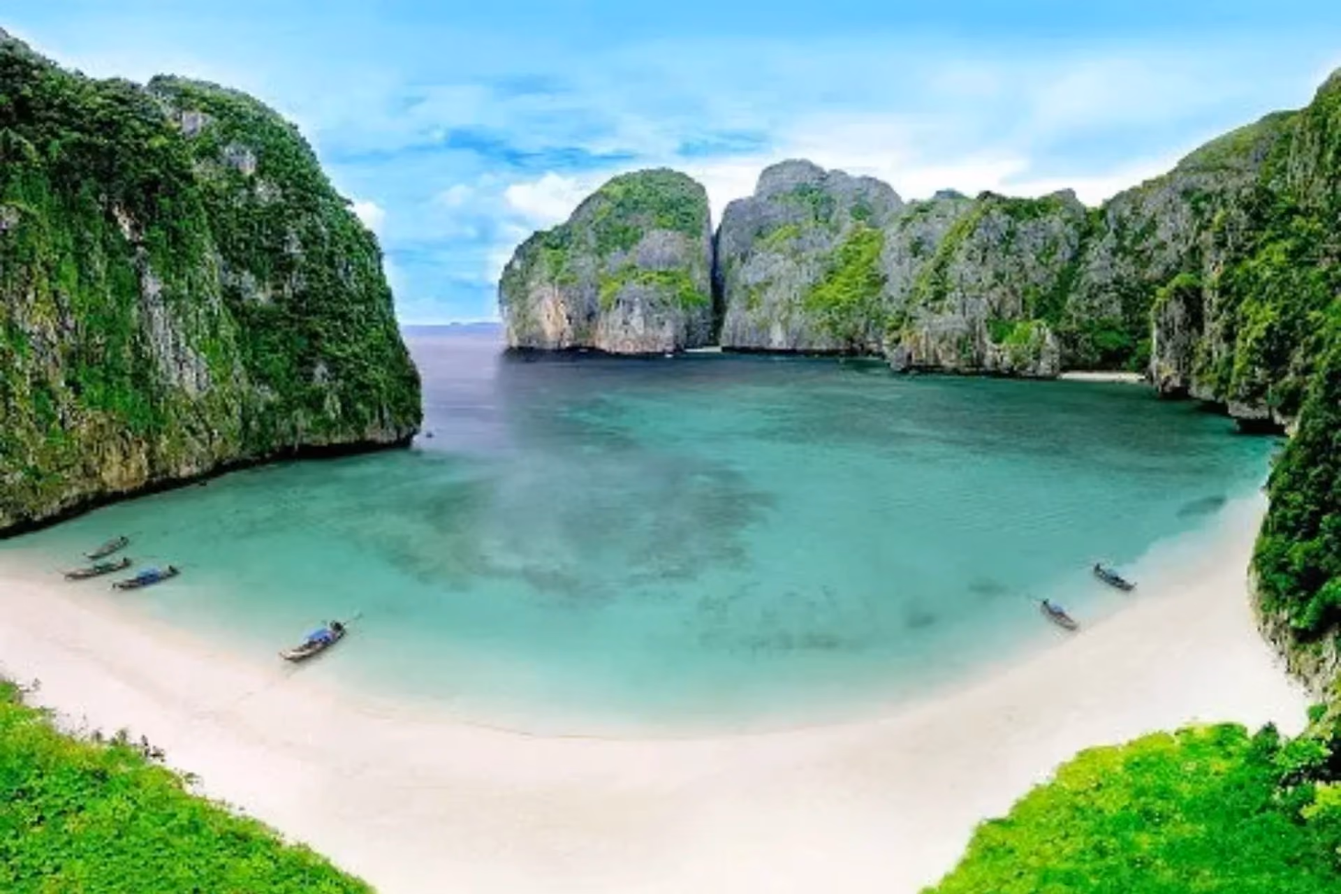 Clear blue-green water and white sand beach at Phi Phi Island