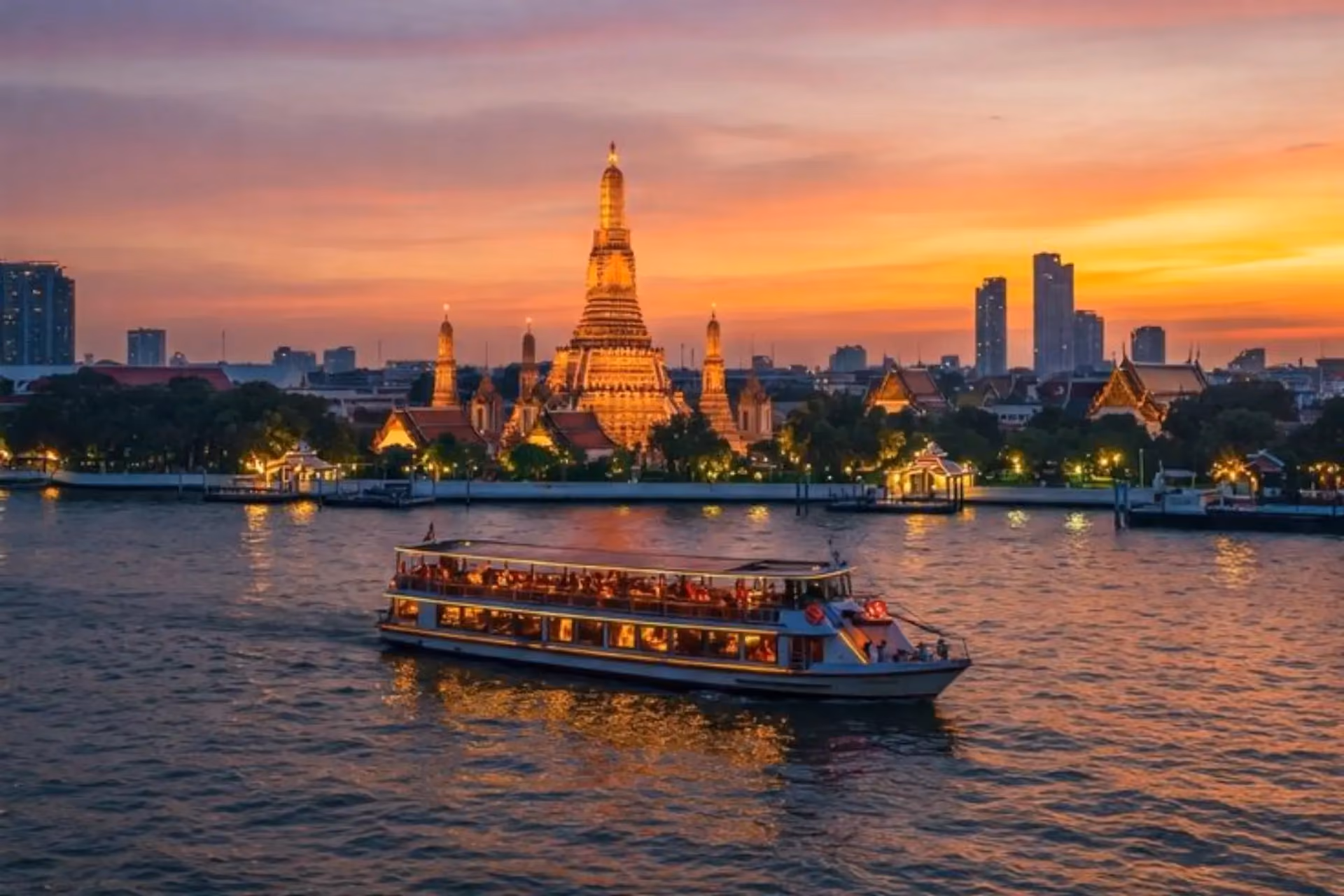 Tourist boat on river at sunset in Bangkok Thailand