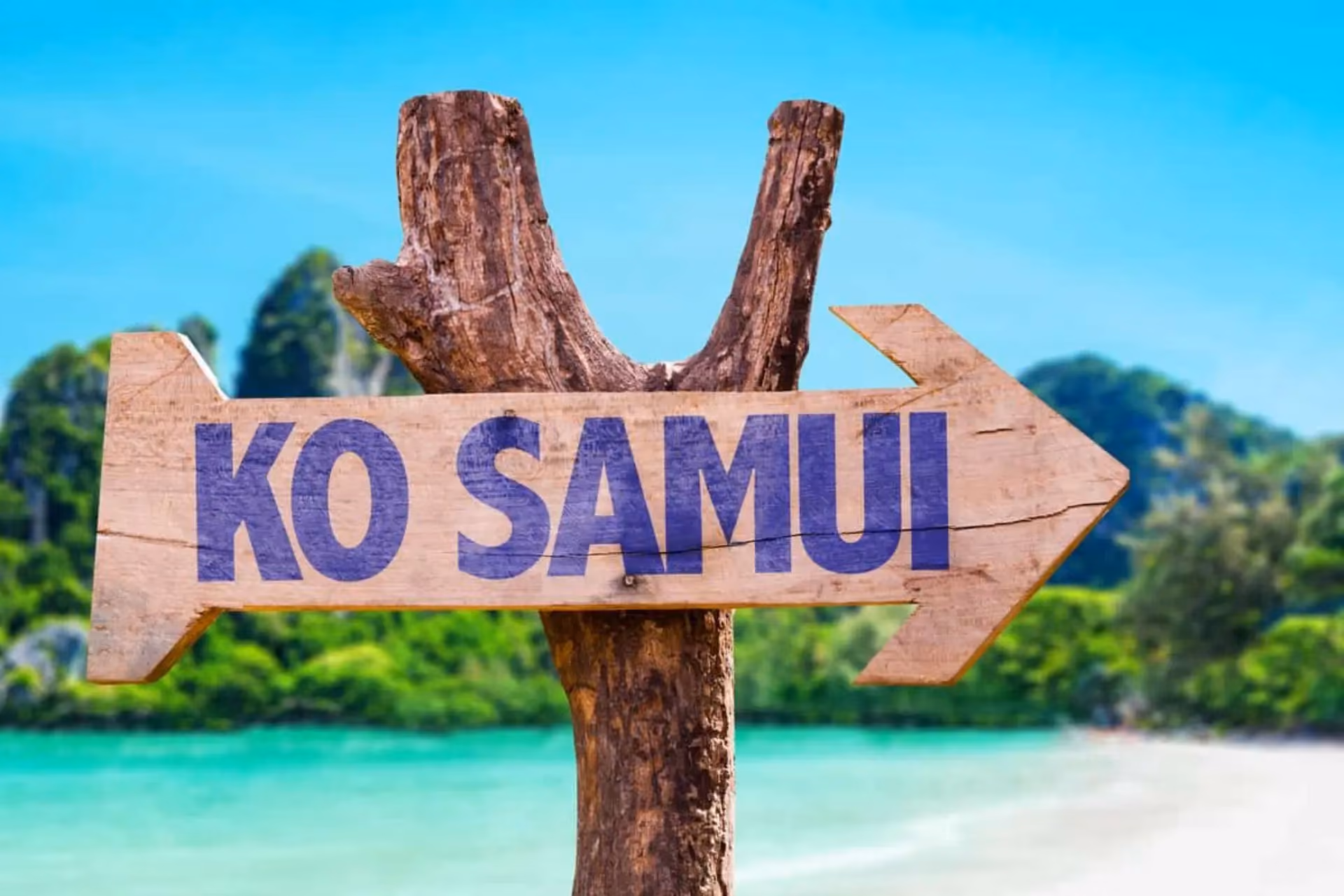 Ko Samui arrow sign pointing at tropical beach and water