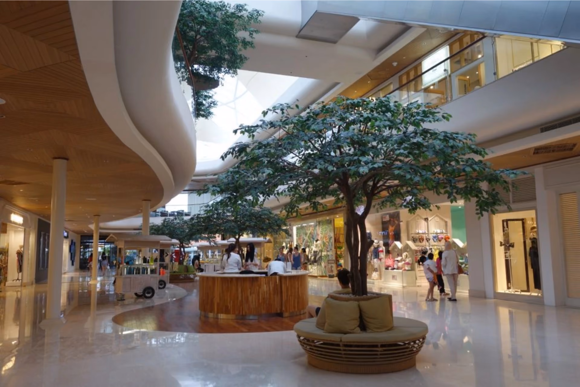 Seminyak Village indoor shopping mall with tree and seating area