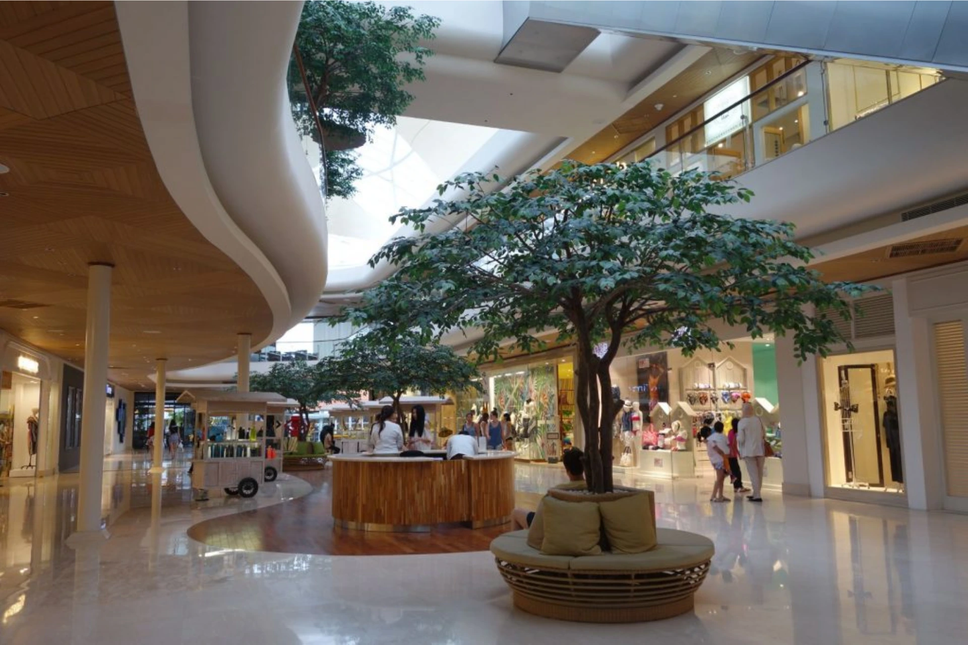 Seminyak Village indoor shopping mall with tree and seating area