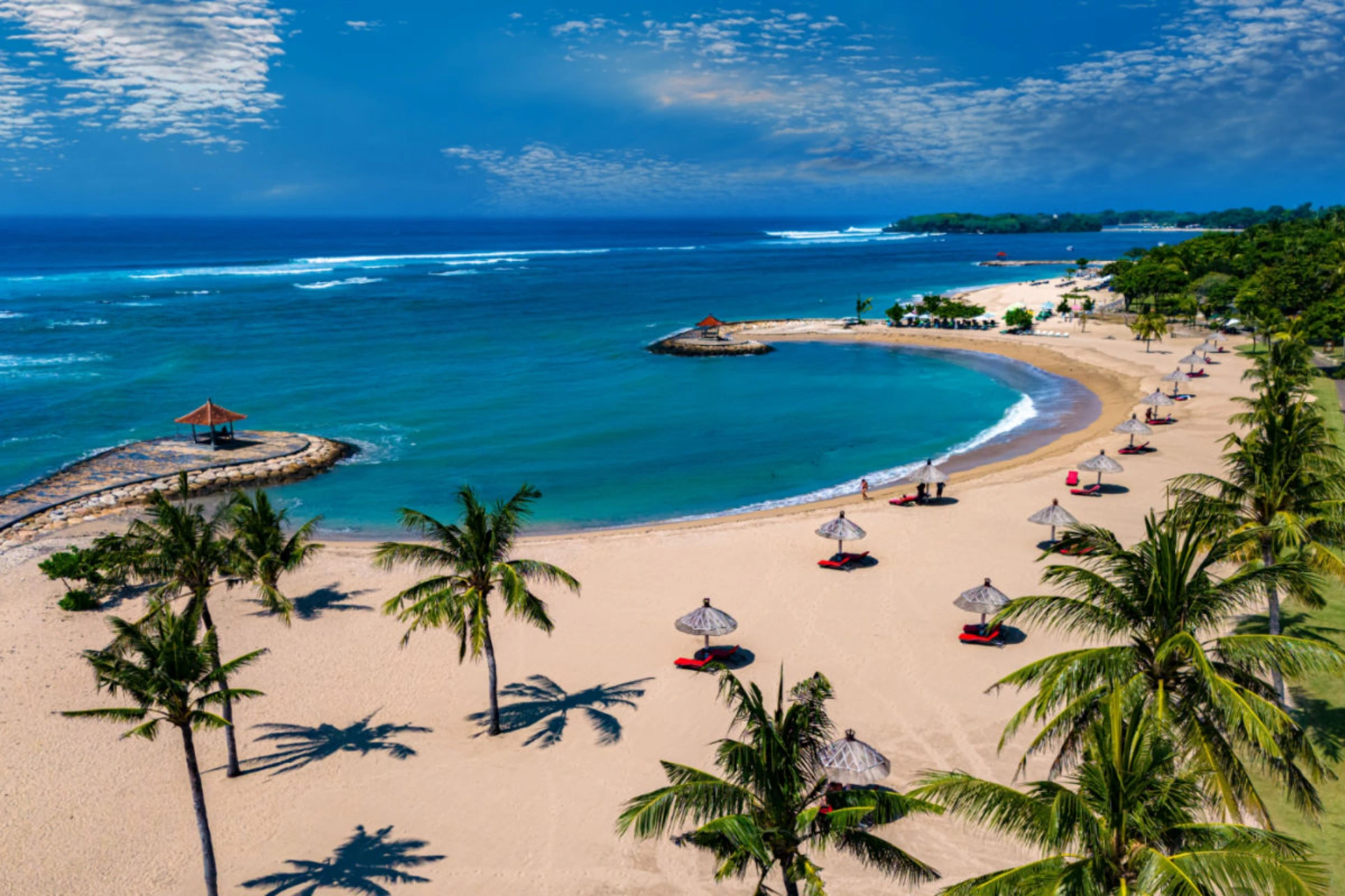 Nusa Dua beach with blue water and sun umbrellas