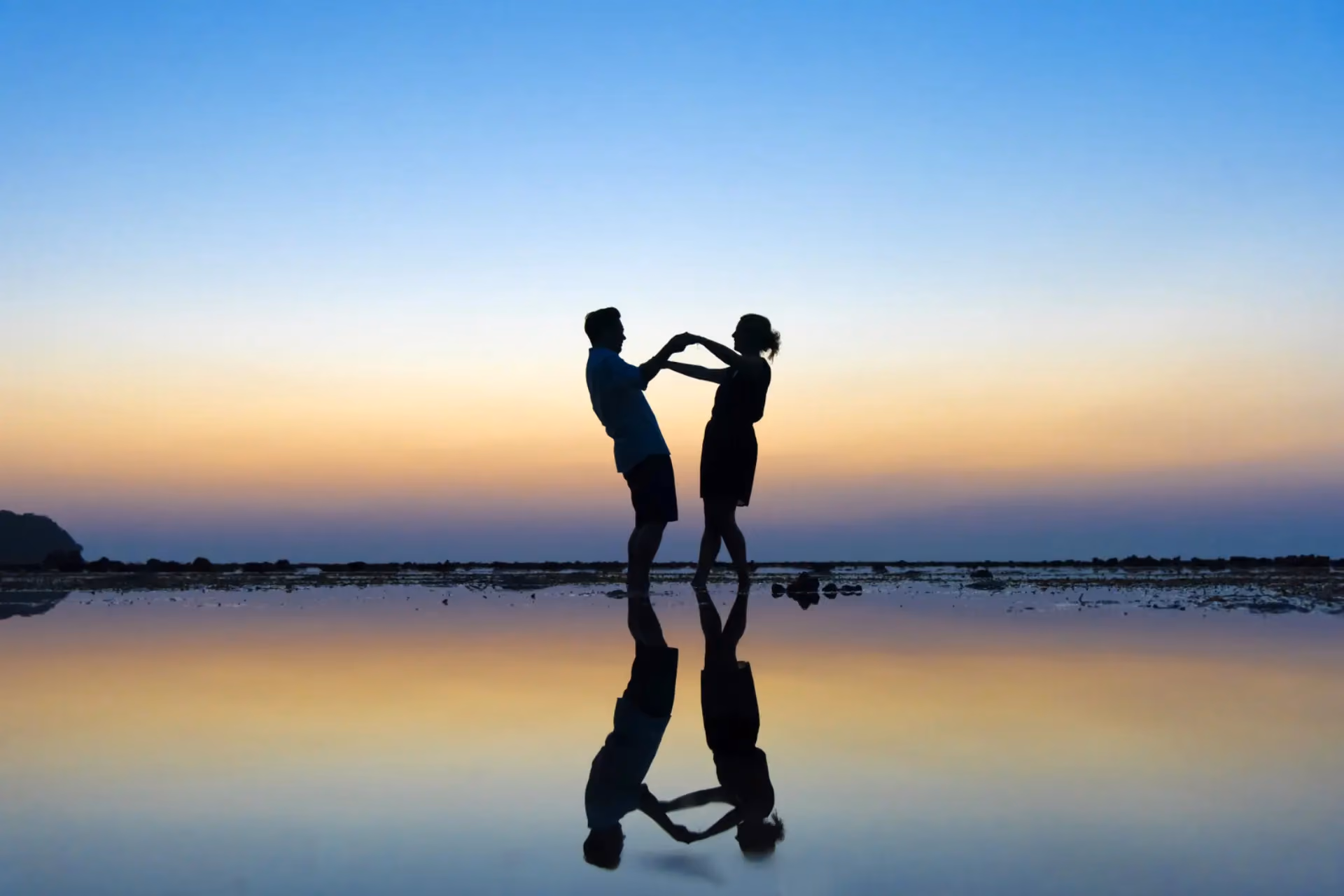 Couple holding hands at sunset in Phuket