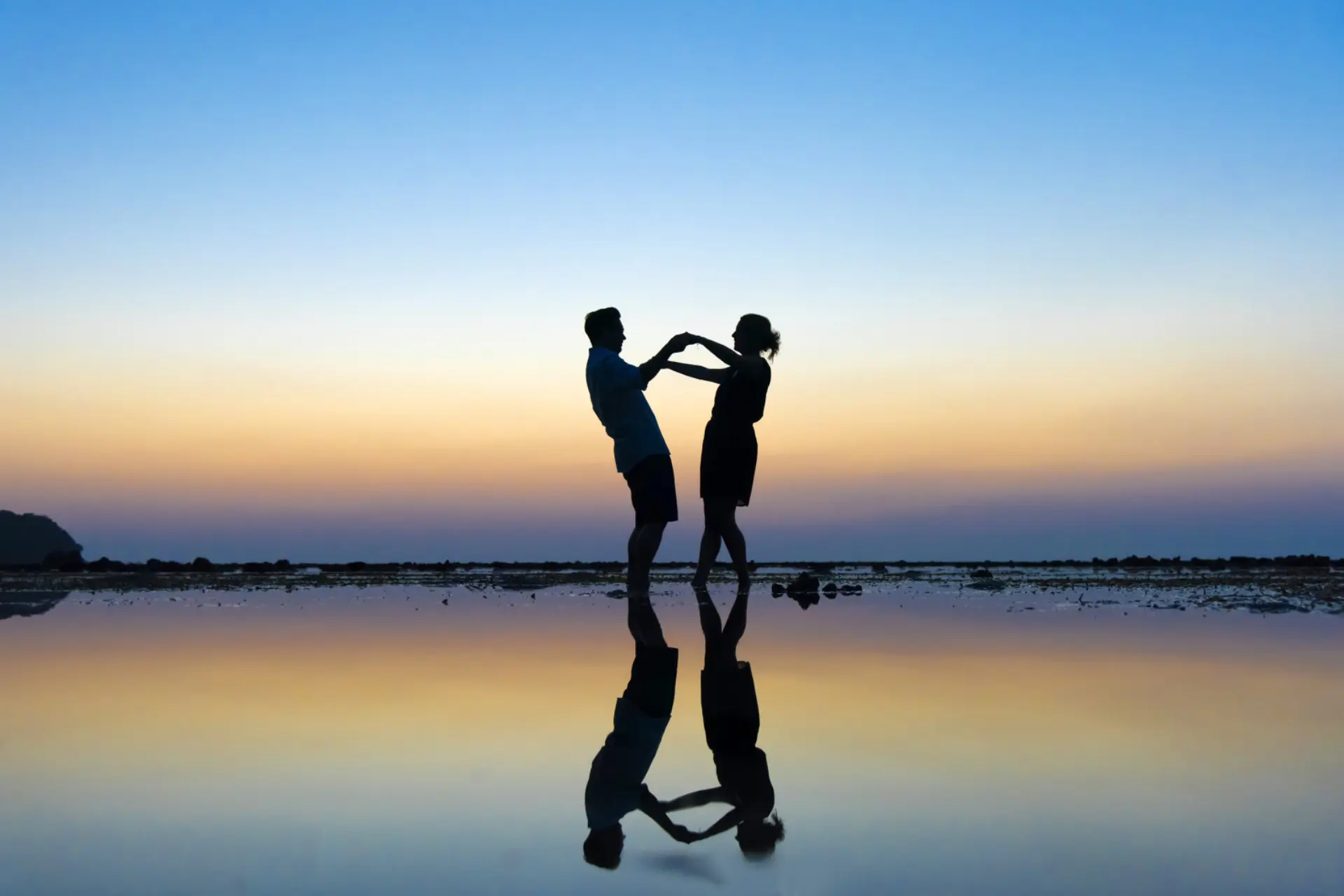 Couple holding hands at sunset in Phuket