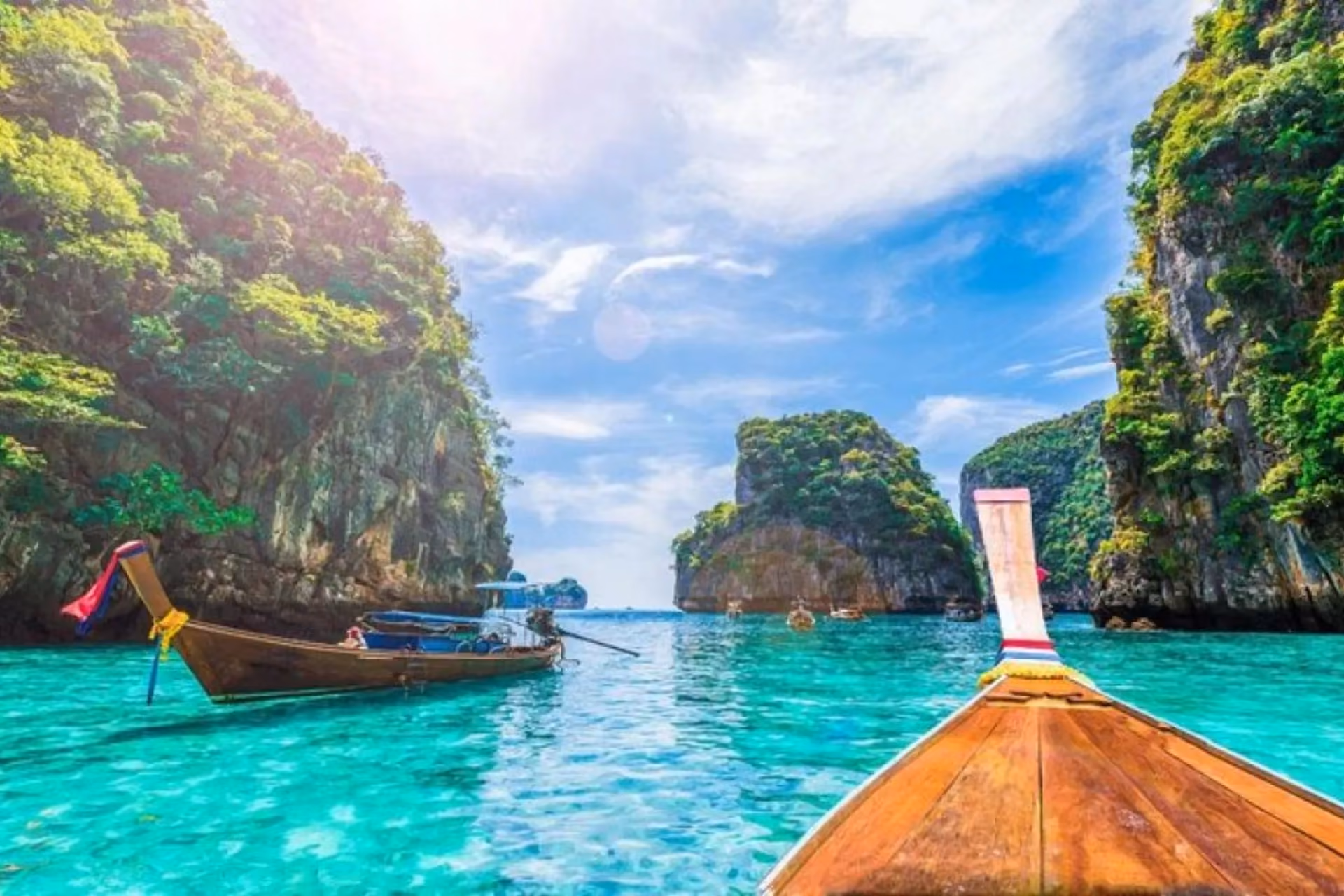 Wooden boat on clear blue water at Phi Phi Don Thailand