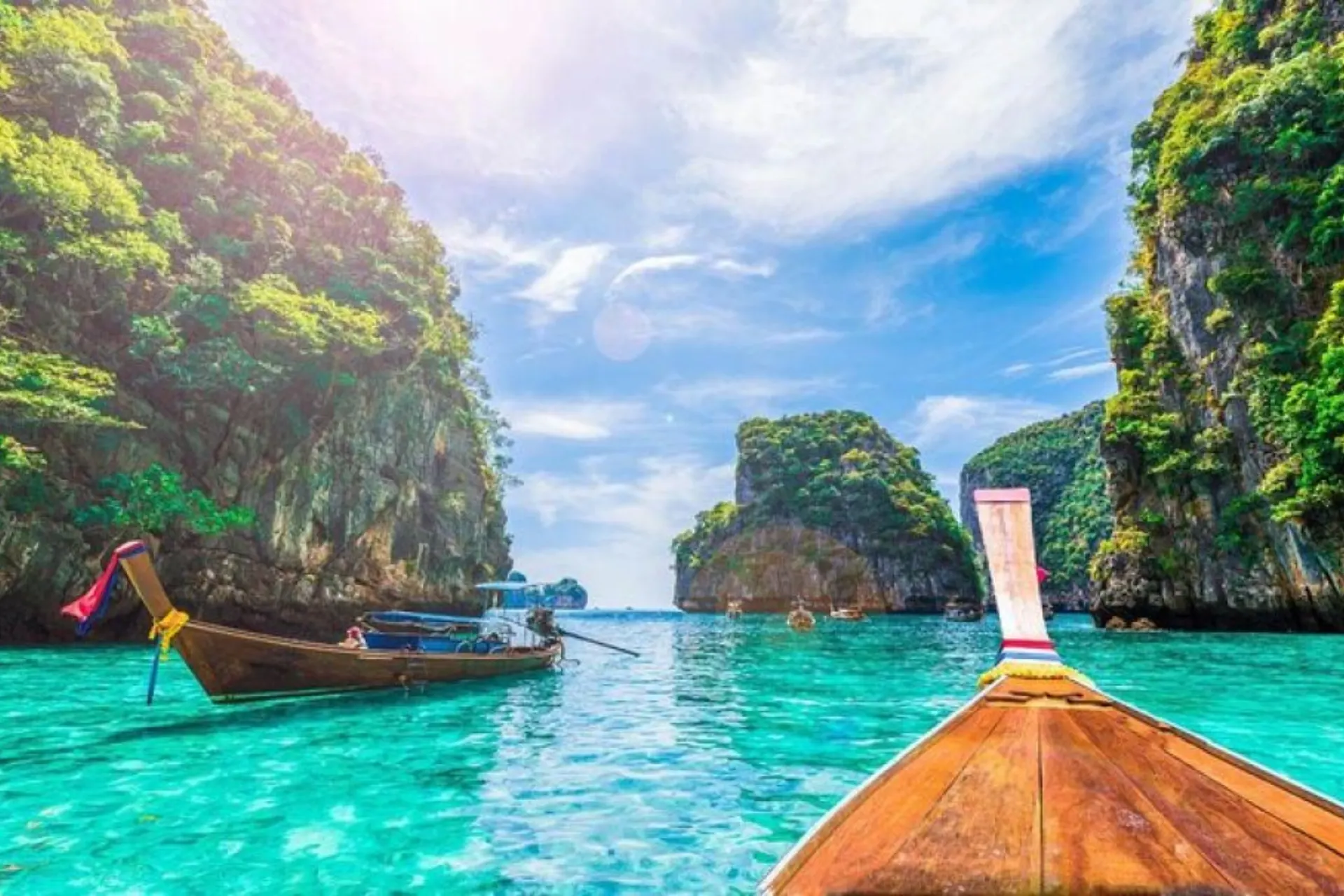 Wooden boat on clear blue water at Phi Phi Don Thailand