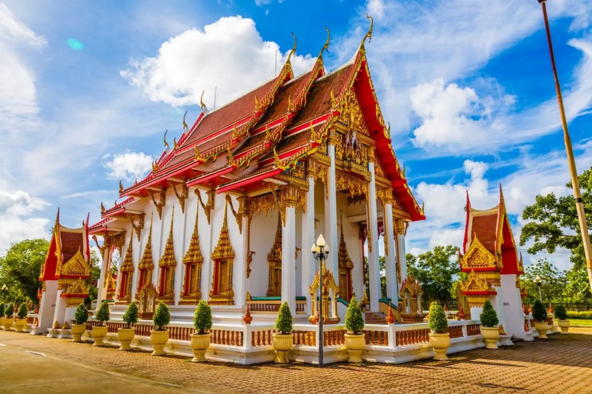 Thai temple with red roof and gold decorations Chalong