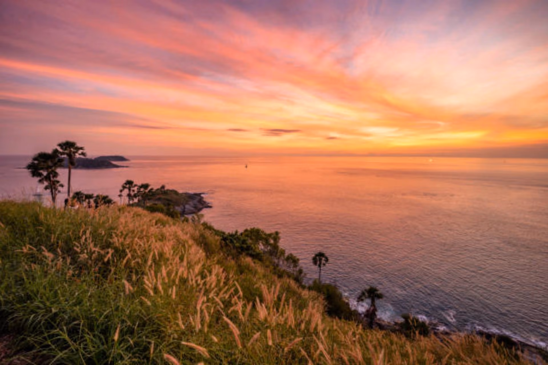 Sunset over ocean from cliff at Promthep Cape Phuket