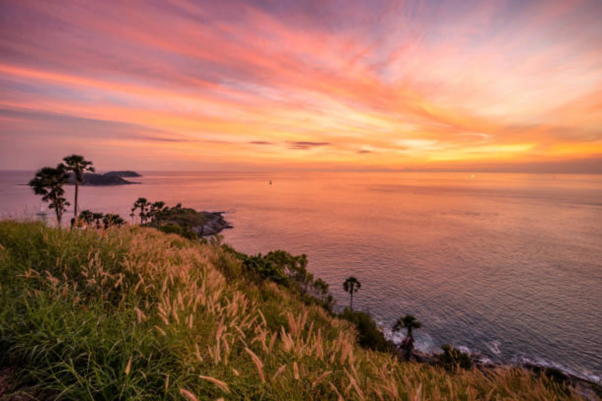 Sunset over ocean from cliff at Promthep Cape Phuket
