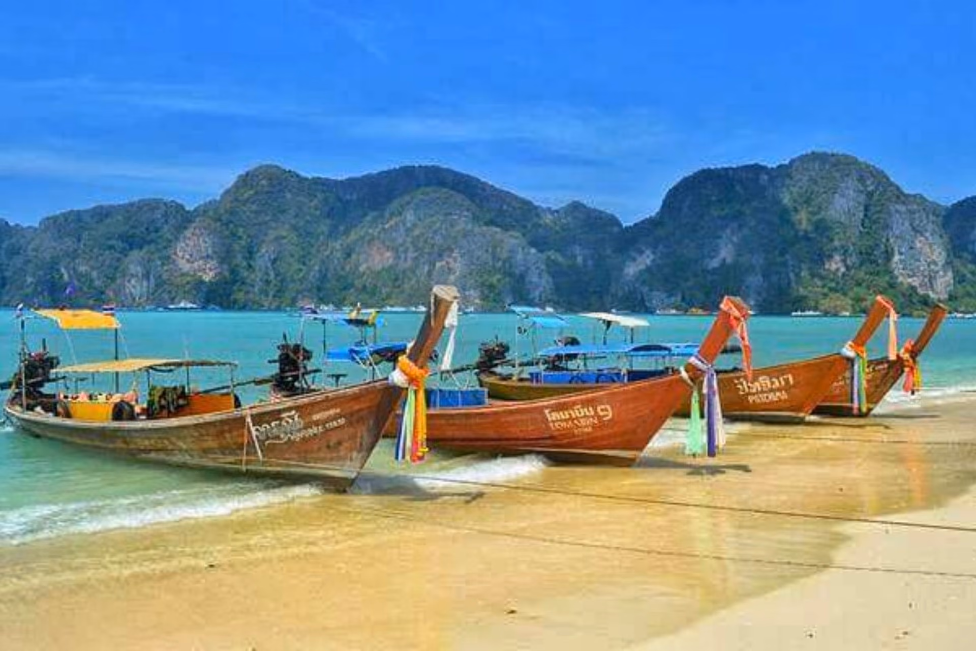 Wooden boats on sand at Ao Nang Beach Thailand