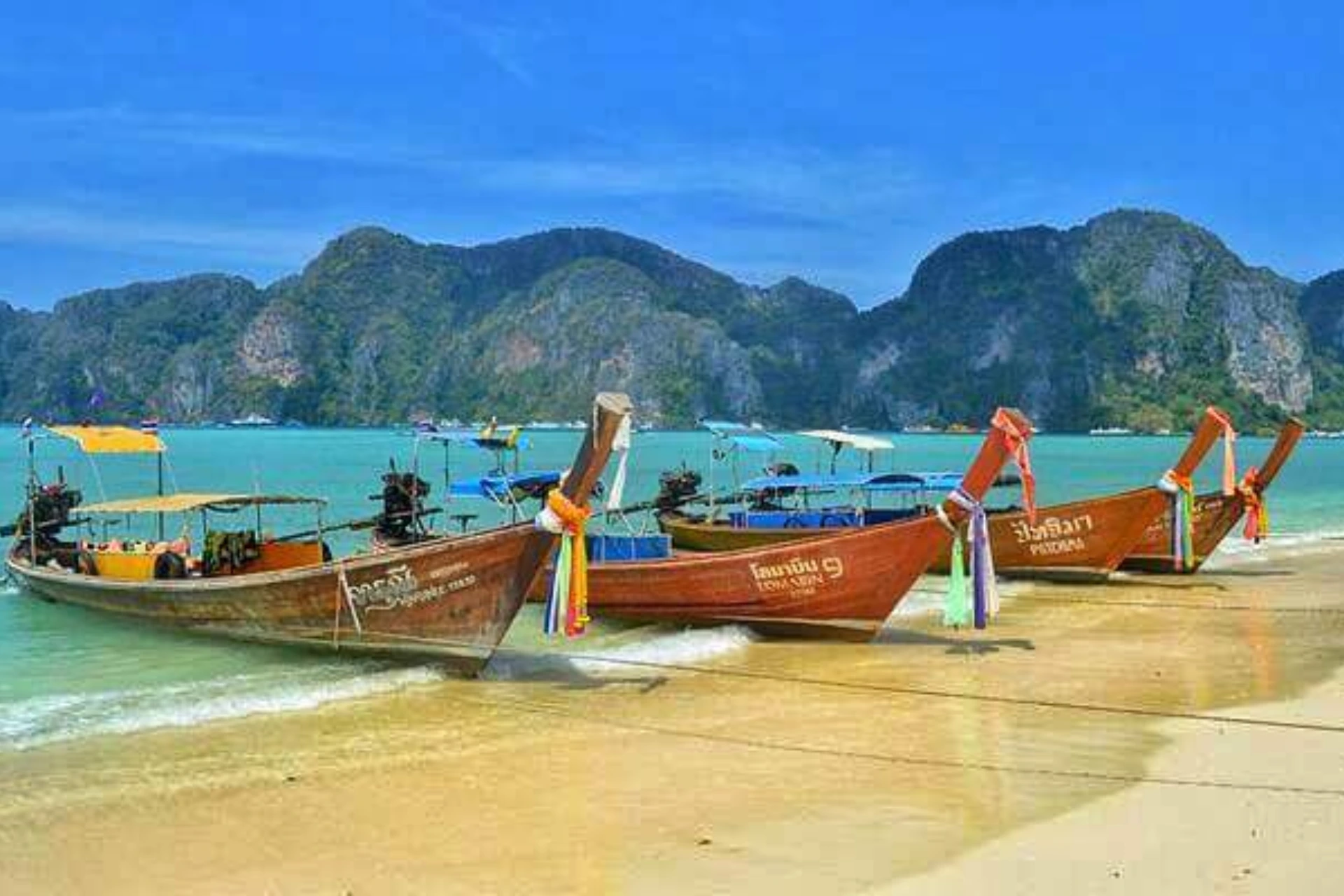 Wooden boats on sand at Ao Nang Beach Thailand