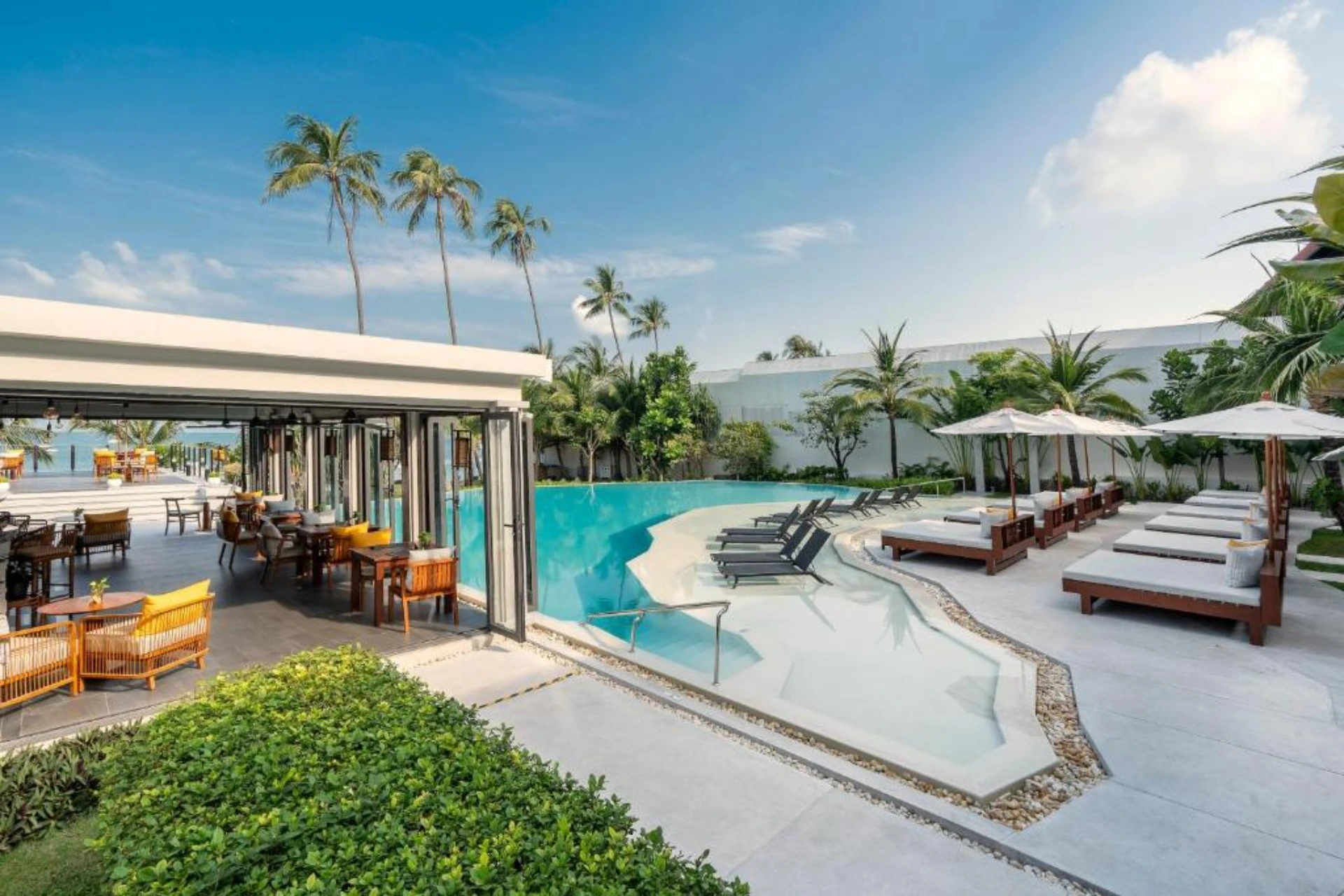 Pool area at The Culture Samui with loungers and palms