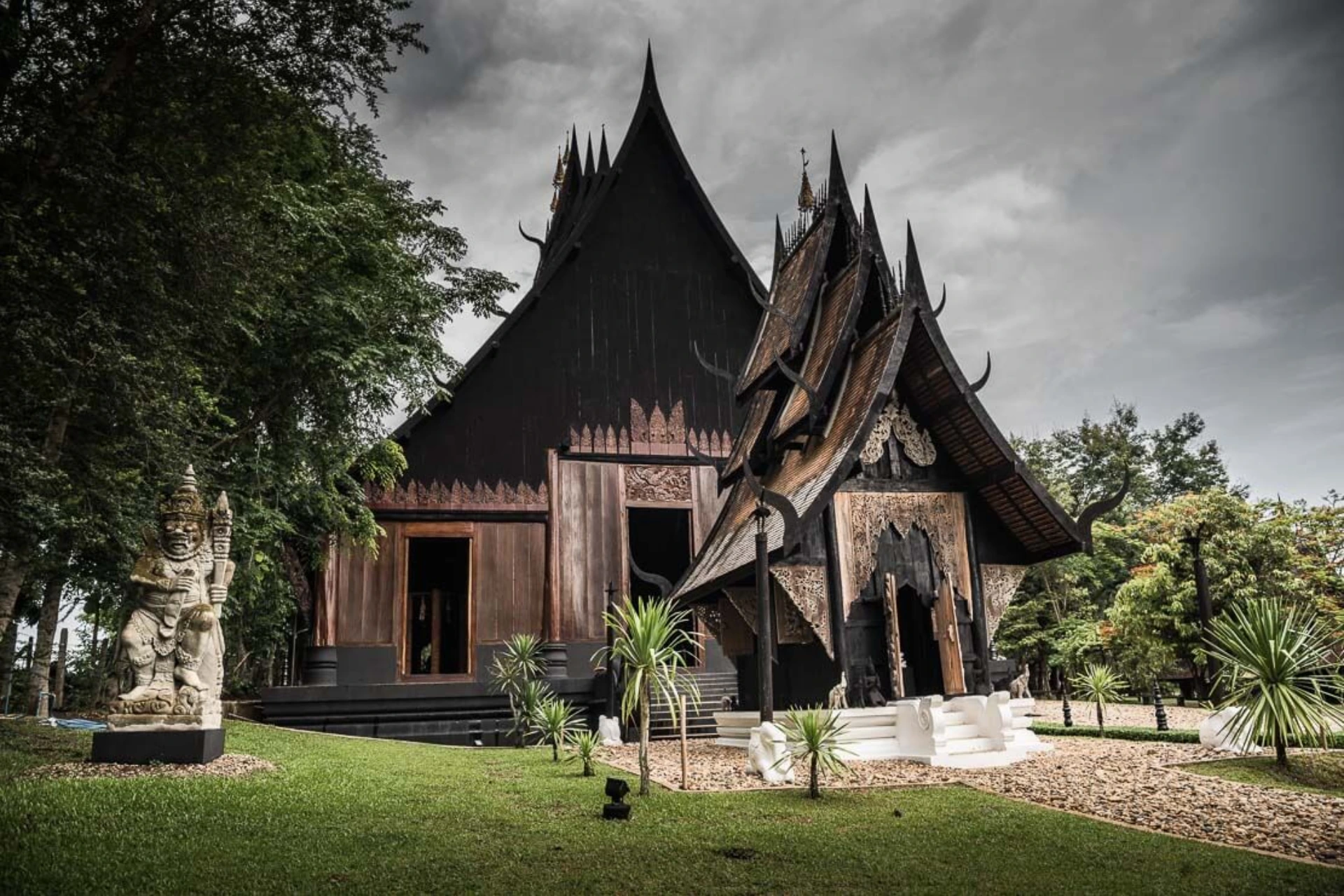 Black wooden temple with pointed roofs in Chiang Mai