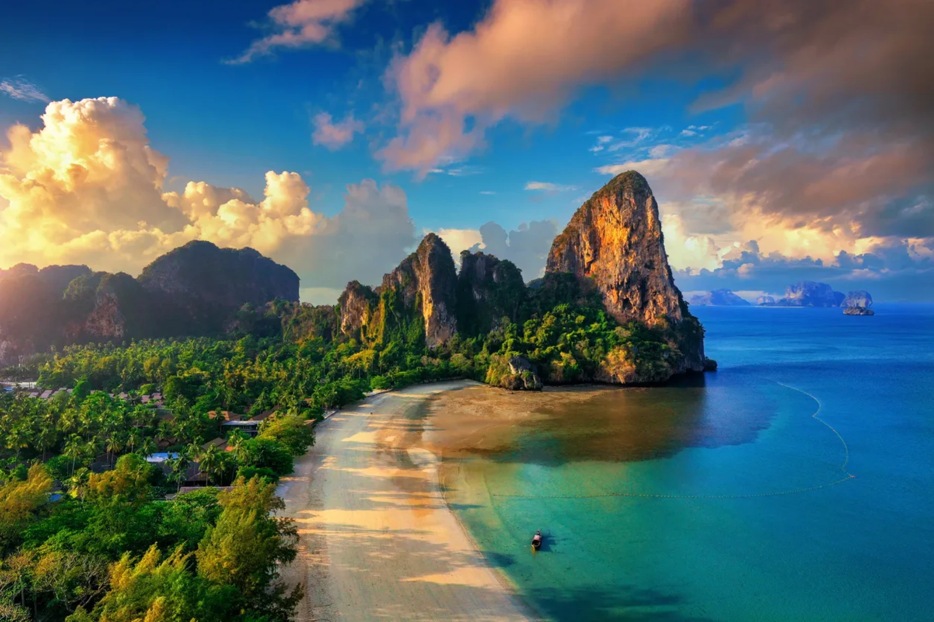 Tall rock cliffs and sandy beach in Krabi Thailand